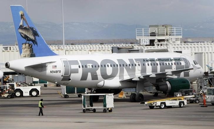 A Frontier Airlines jet loads at the Denver International Airport