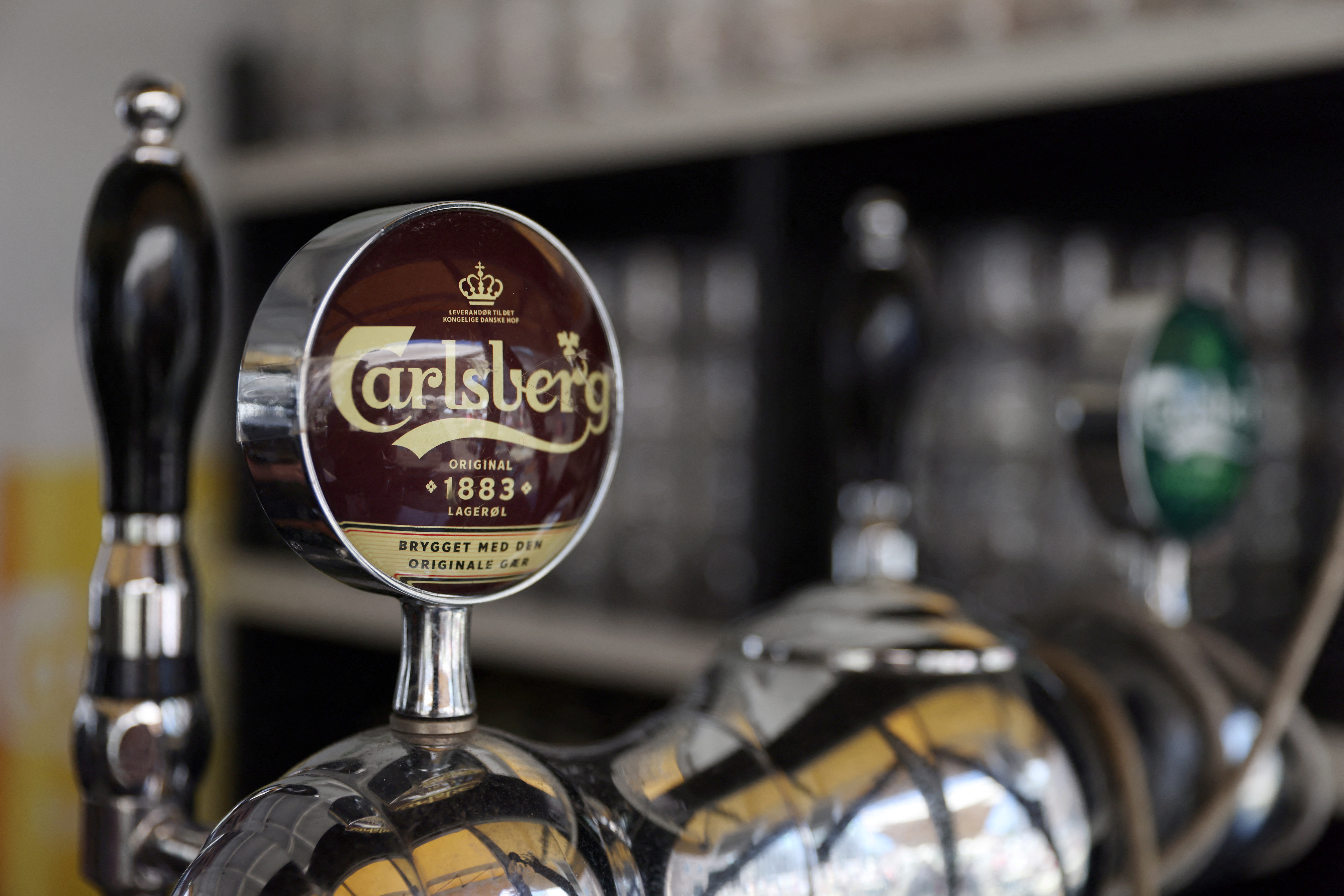 Taps for Carlsberg beer are seen in a bar in Copenhagen