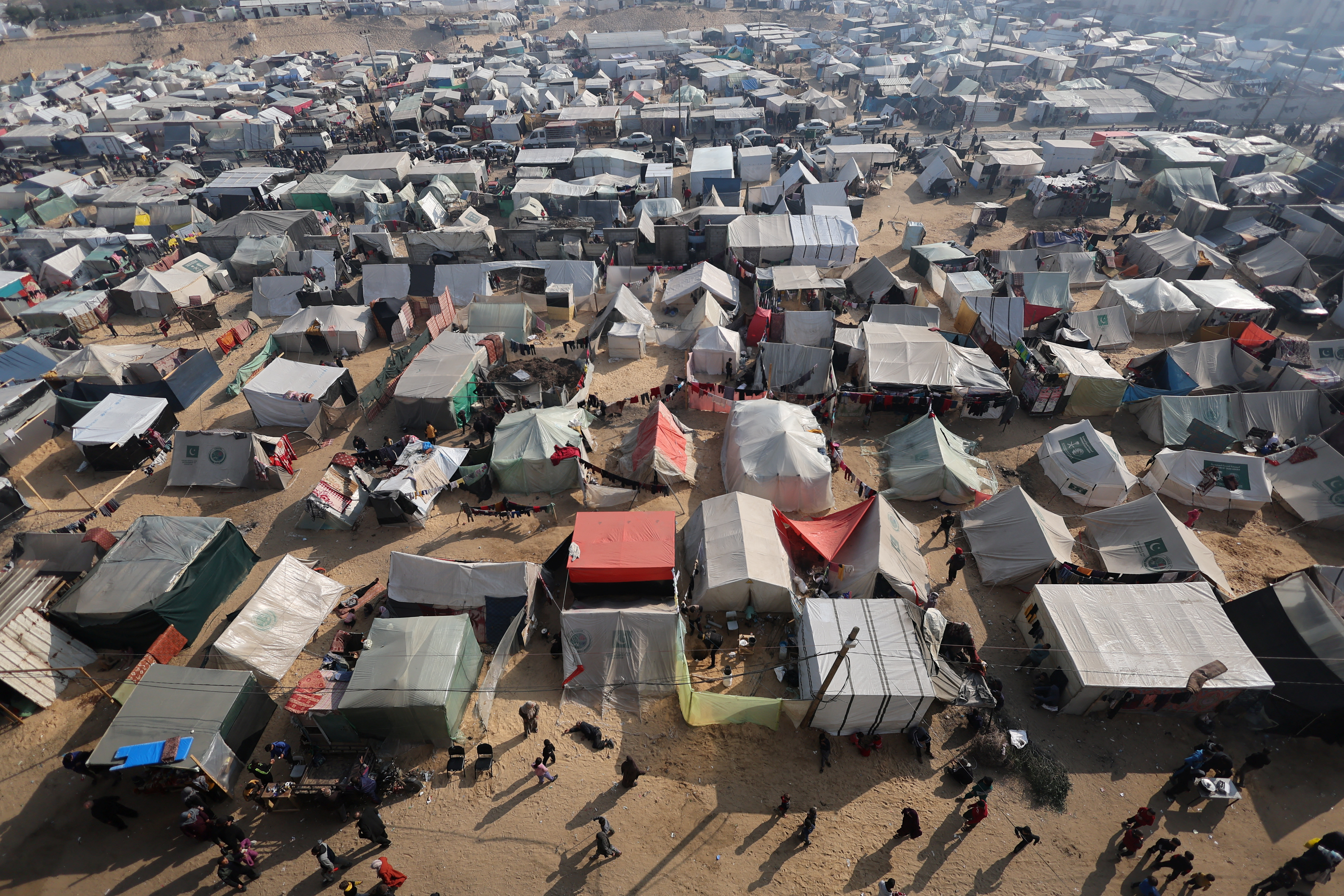 Displaced Palestinians, who fled their homes due to Israeli strikes, shelter in a tent camp in Rafah