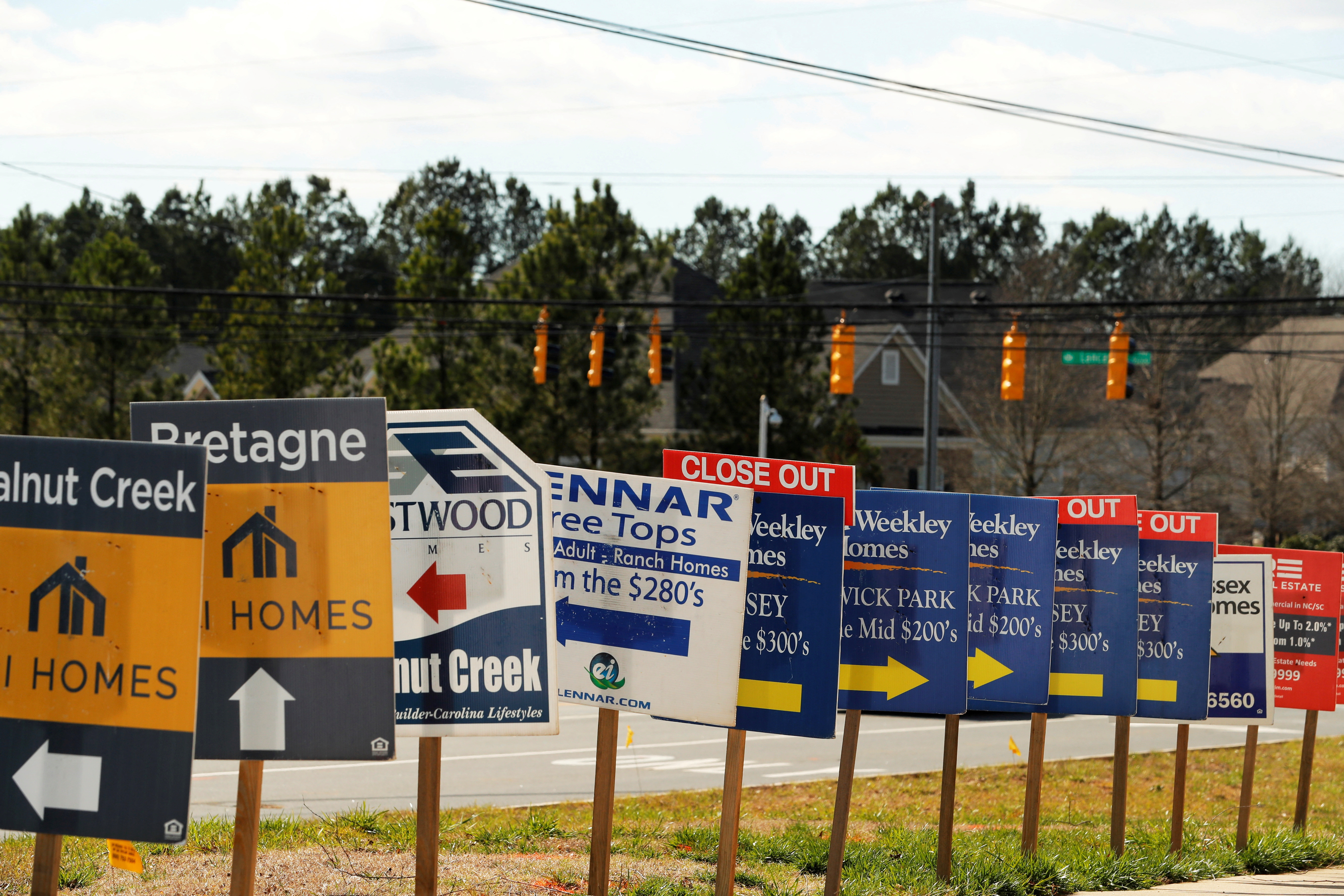 Real estate signs advertise new homes for sale in multiple new developments in York County, South Carolina