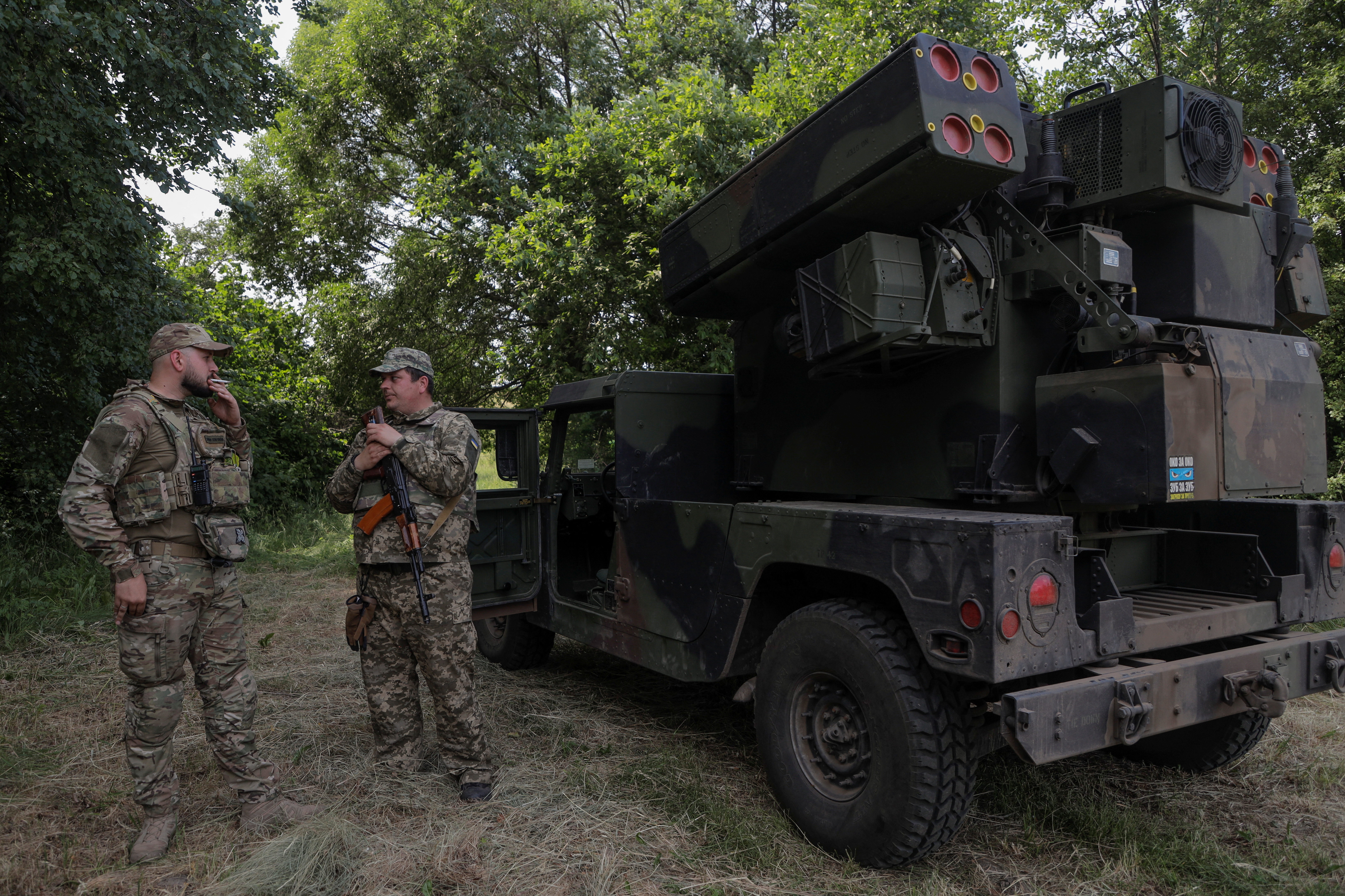 Ukrainian servicemen stand next to an AN/TWQ-1 Avenger mobile air defence missile system outside of Kyiv