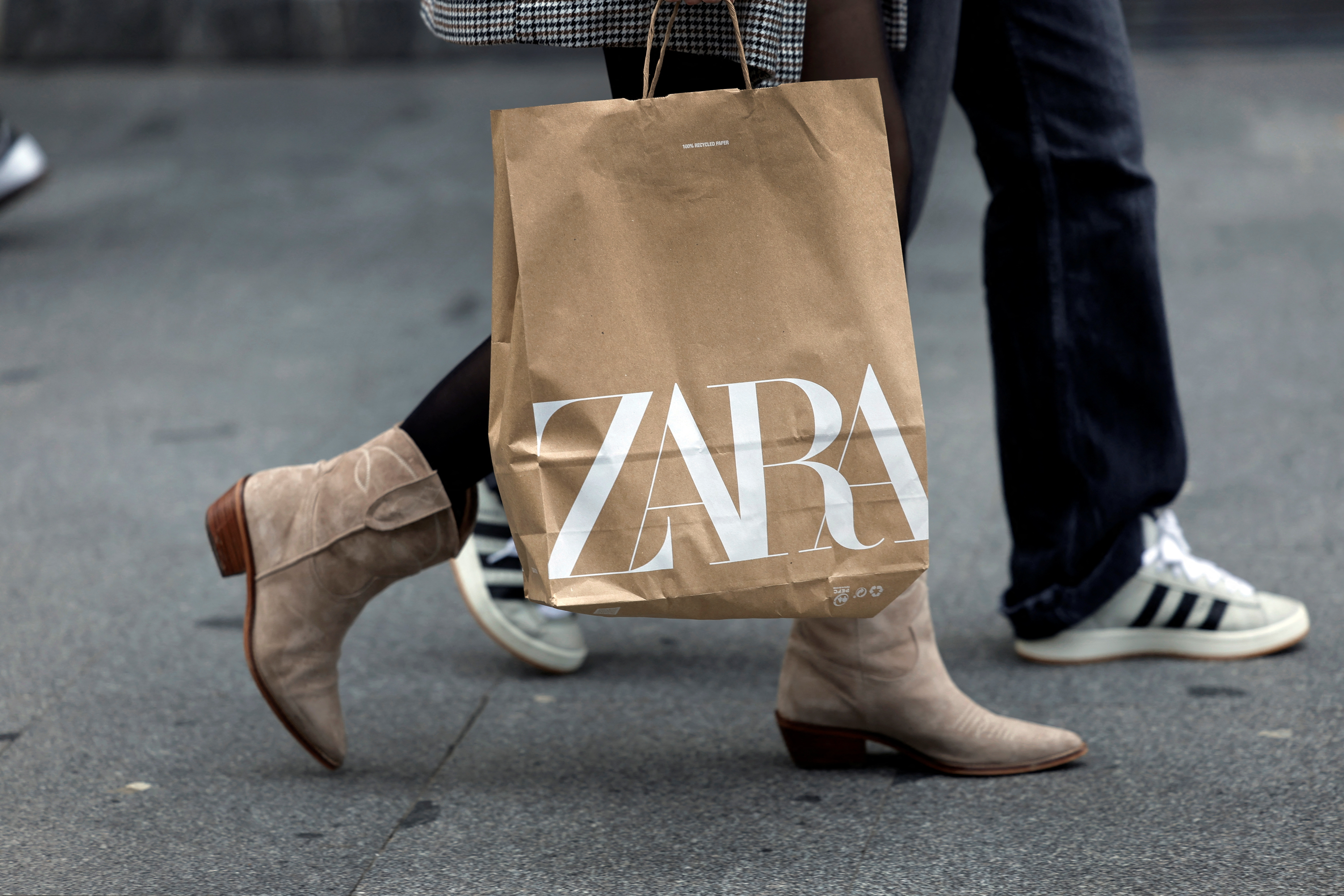 A woman carries a bag from Spanish multinational retail clothing chain Zara, in Bilbao