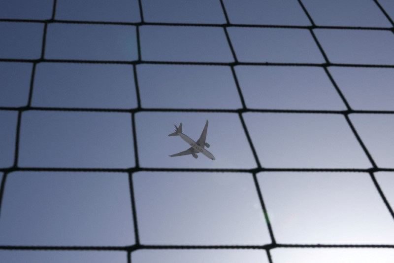 A Qatar Airways plane flies over Dubai