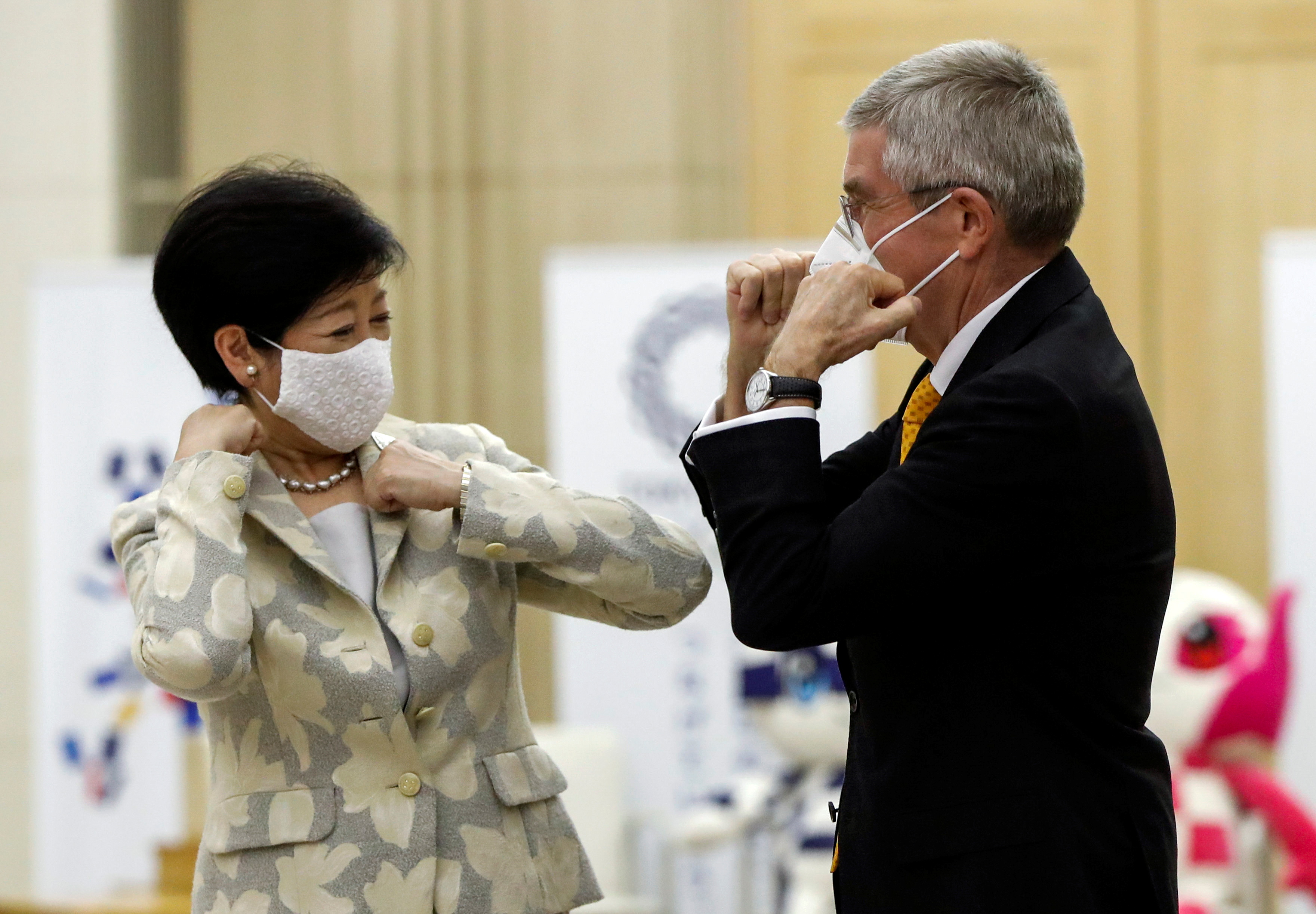 Tokyo Governor Yuriko Koike and Thomas Bach, President of the International Olympic Committee (IOC), bump elbows at the start of their talks at Tokyo Metropolitan Government Office Building in Tokyo