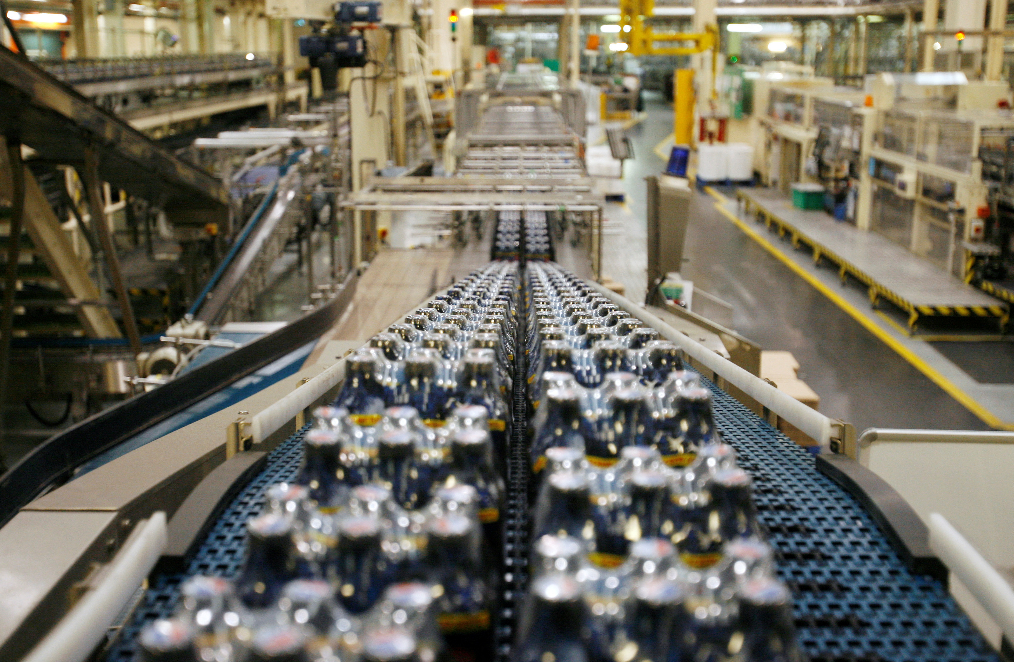 Bottles soft drinks made by drinks company Britvic sit on a conveyor belt at  Britvic's bottling plant in London