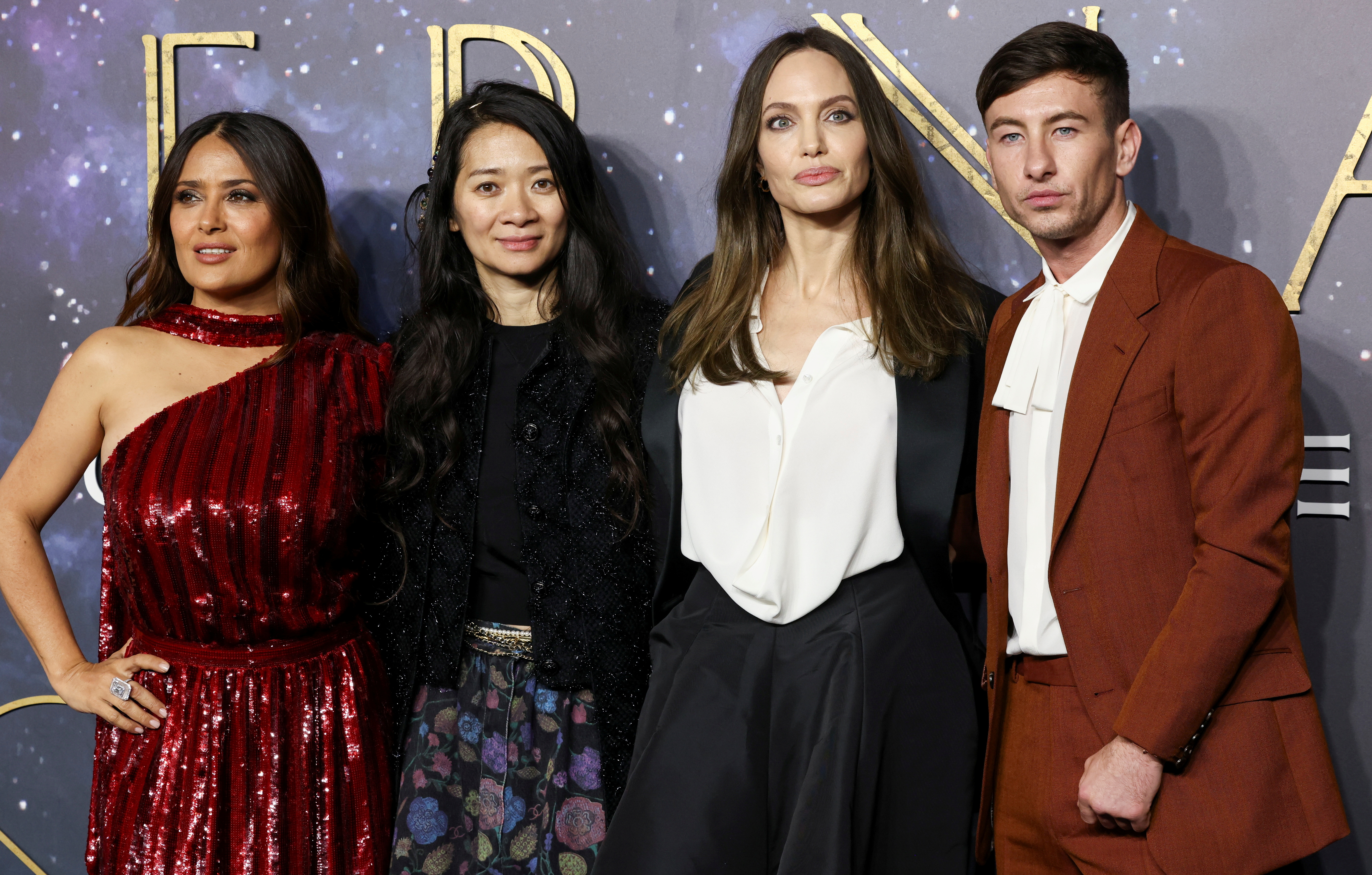 Director Chloe Zhao poses with cast members Salma Hayek, Angelina Jolie and Barry Keoghan as they arrive for a screening of the film 