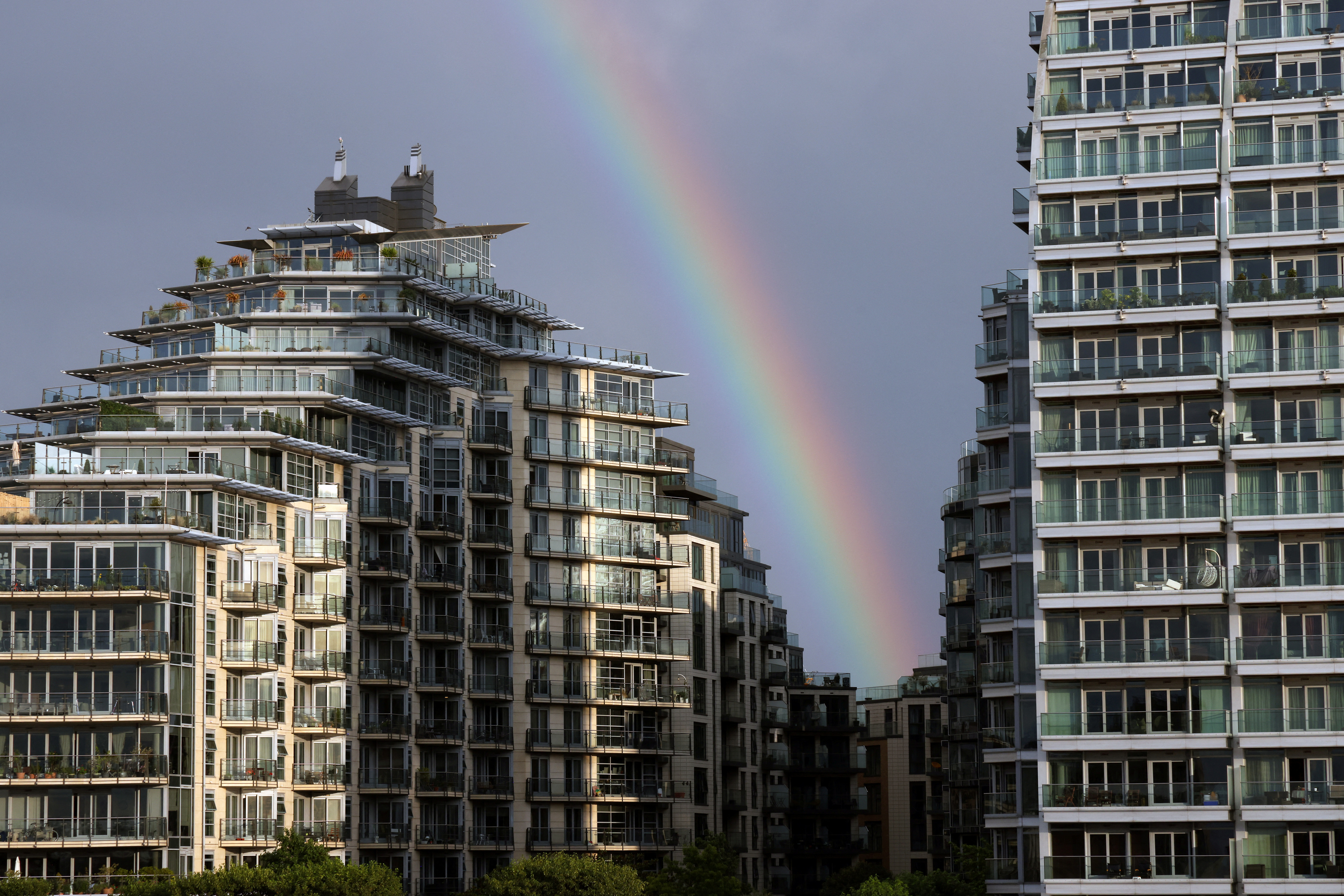 A rainbow is seen over apartments in Wandsworth on the River Thames