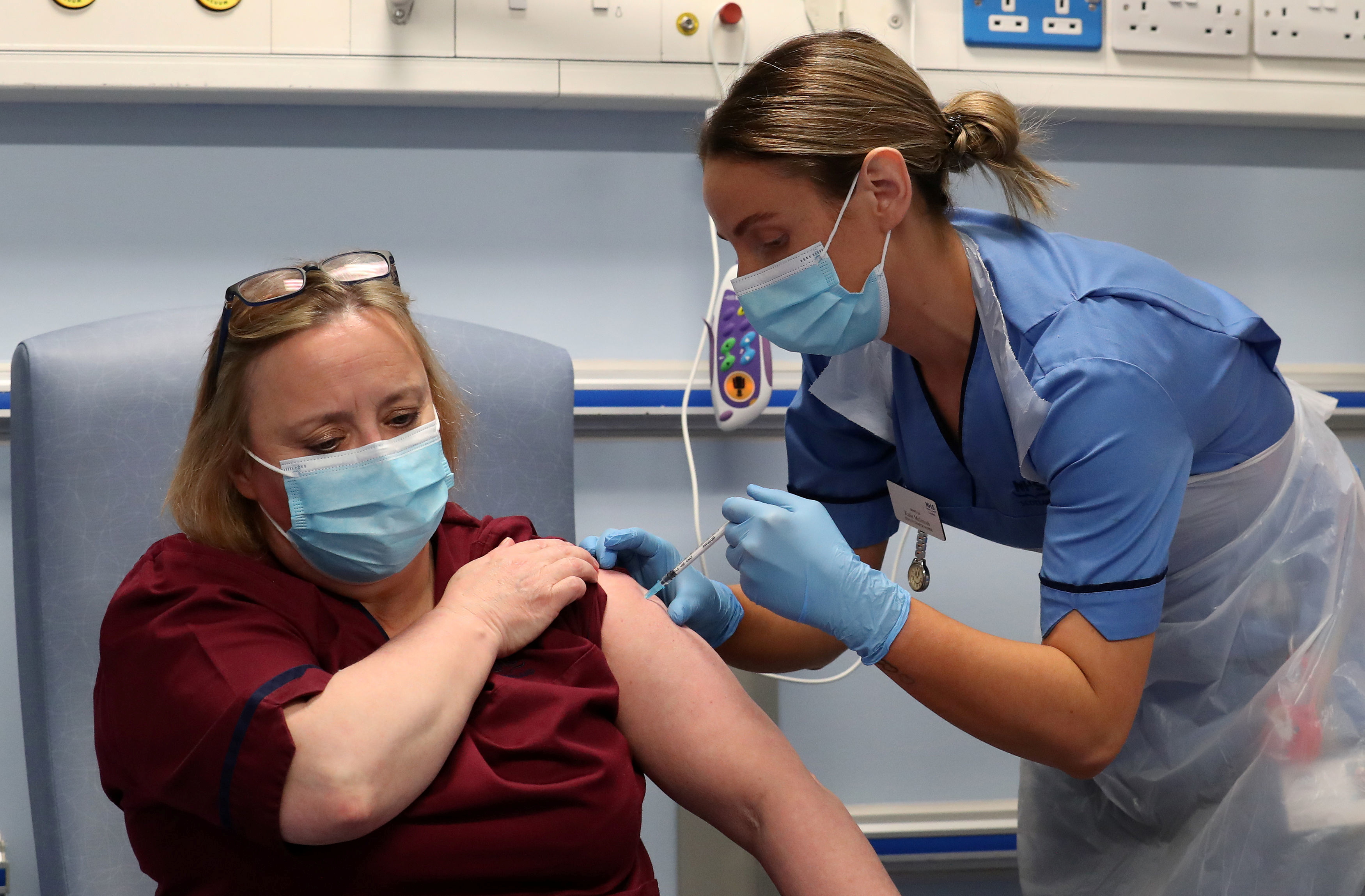 Deputy charge nurse Katie McIntosh administers the first of two Pfizer/BioNTech COVID-19 vaccine jabs, to Vivien McKay Clinical Nurse Manager at the Western General Hospital in Edinburgh
