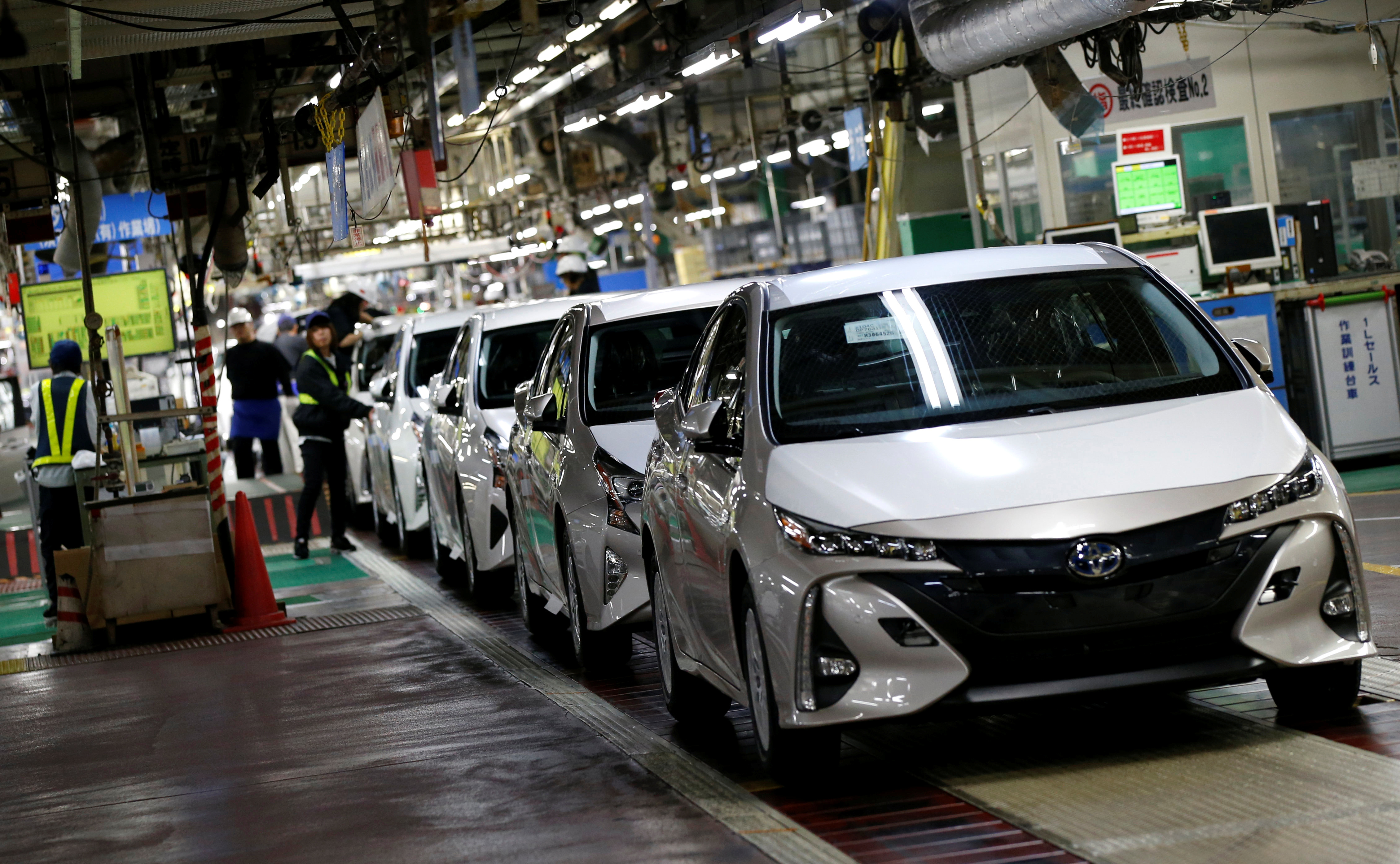 Toyota Motor Corp's Prius PHV and Prius hybrid cars are seen on the assembly line of Toyota Motor Corp's Tsutsumi plant in Toyota