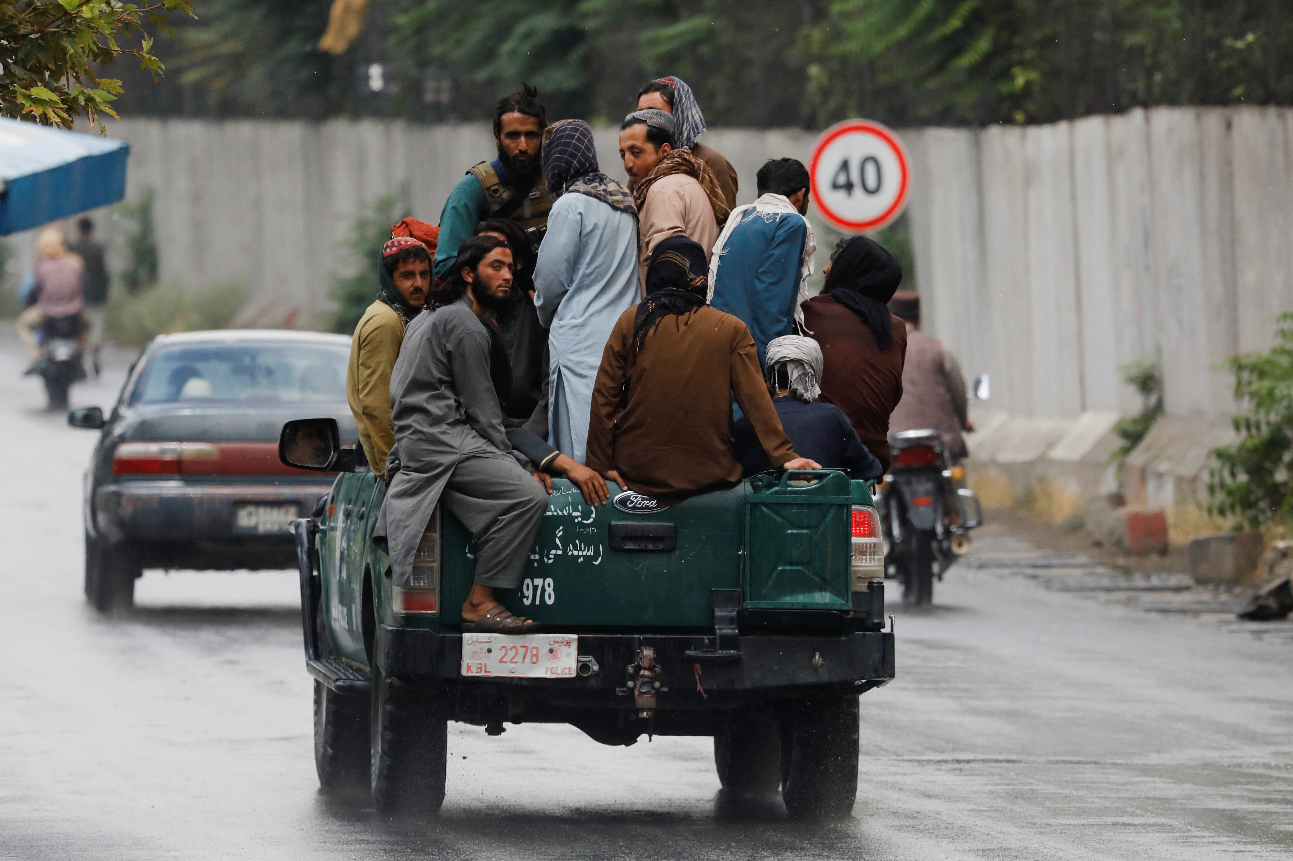 Taliban fighters drive a car on a street following the killing of Al Qaeda leader Ayman al-Zawahiri in a U.S. strike over the weekend, in Kabul
