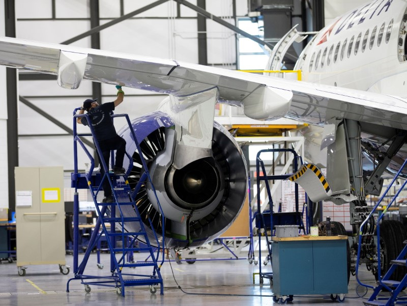 An employee works on an Airbus A220-300 at their facility in Mirabel