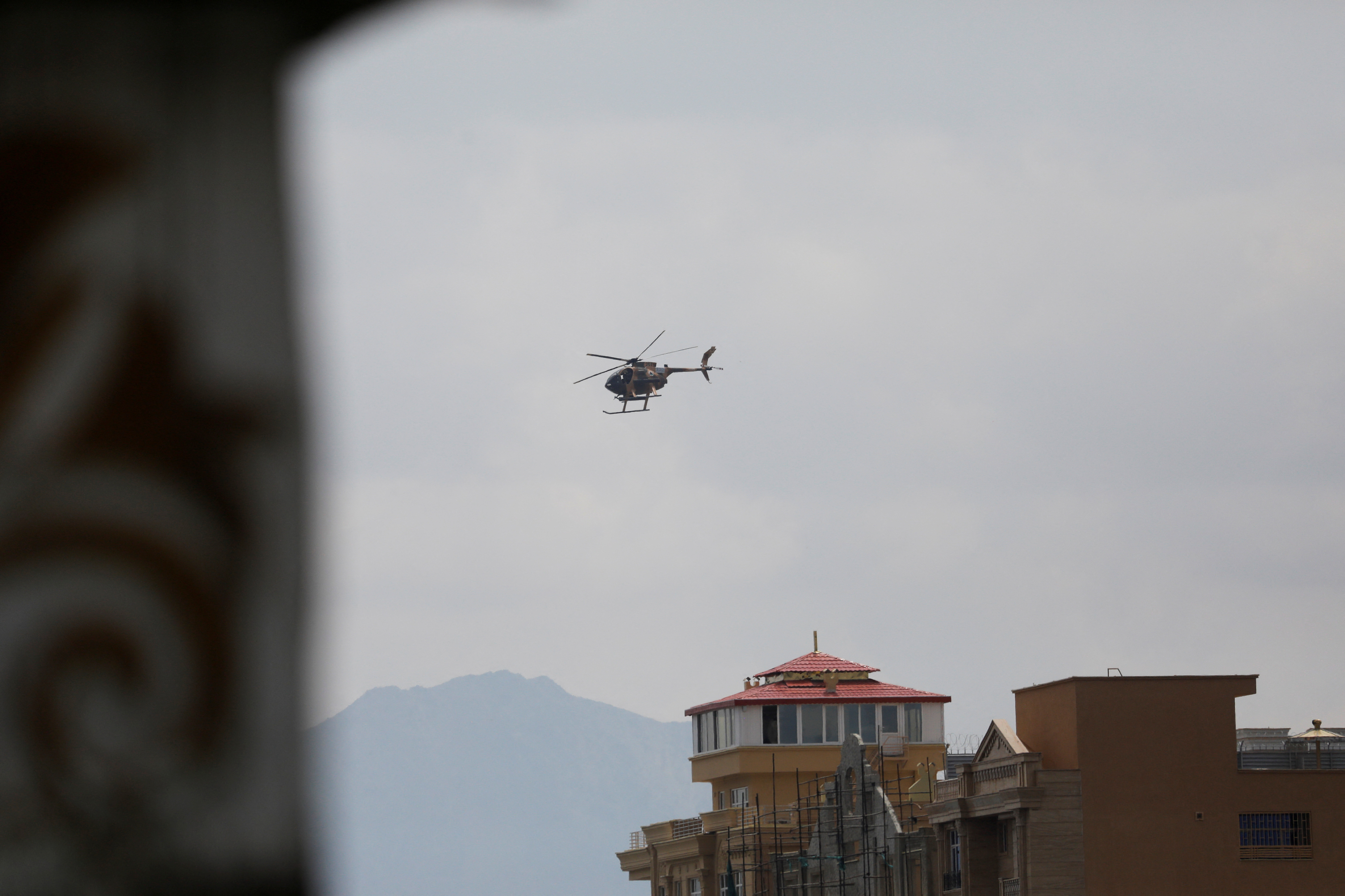 A Taliban military helicopter flies over Kabul