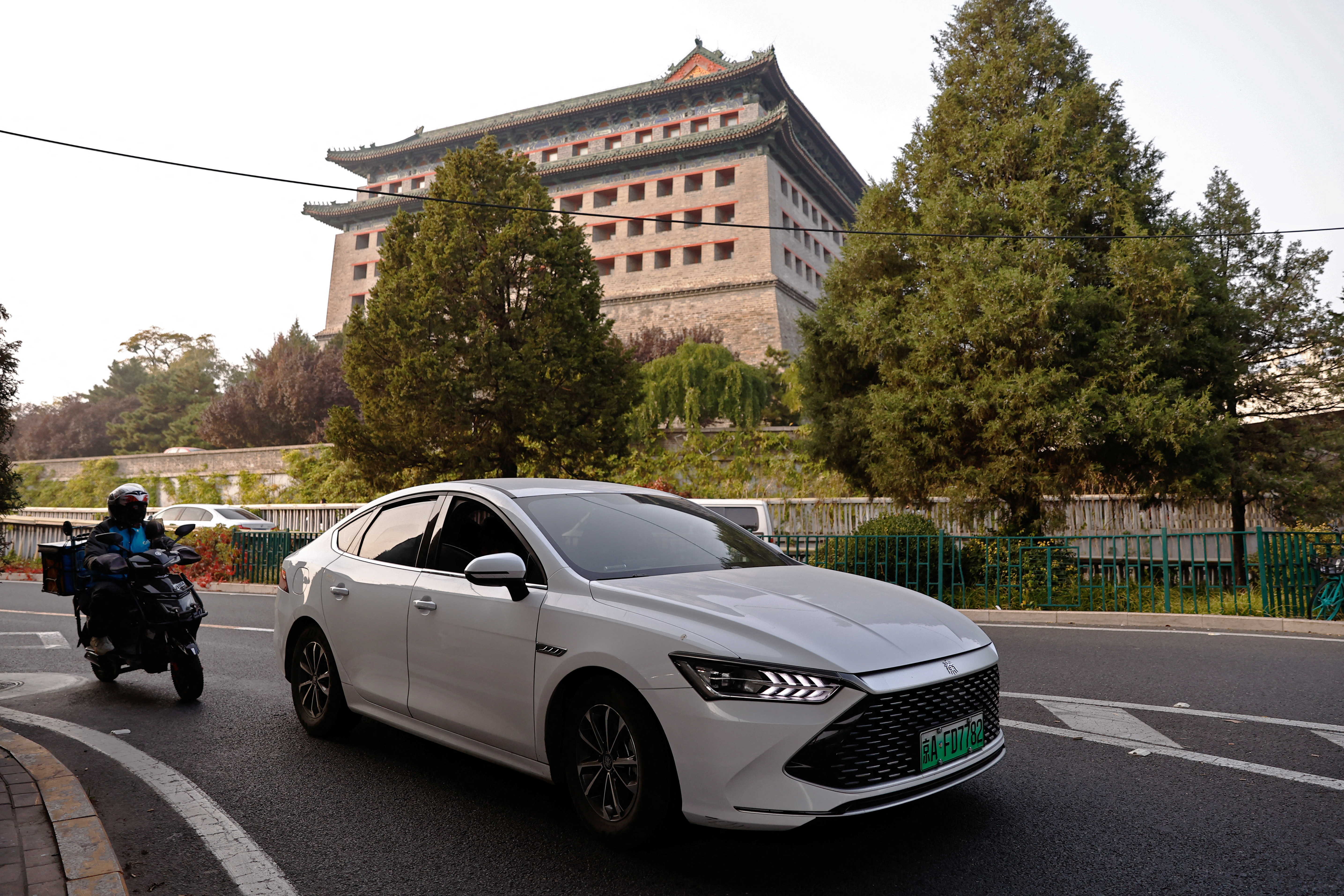BYD's electric vehicle (EV) Qin moves on a street in Beijing