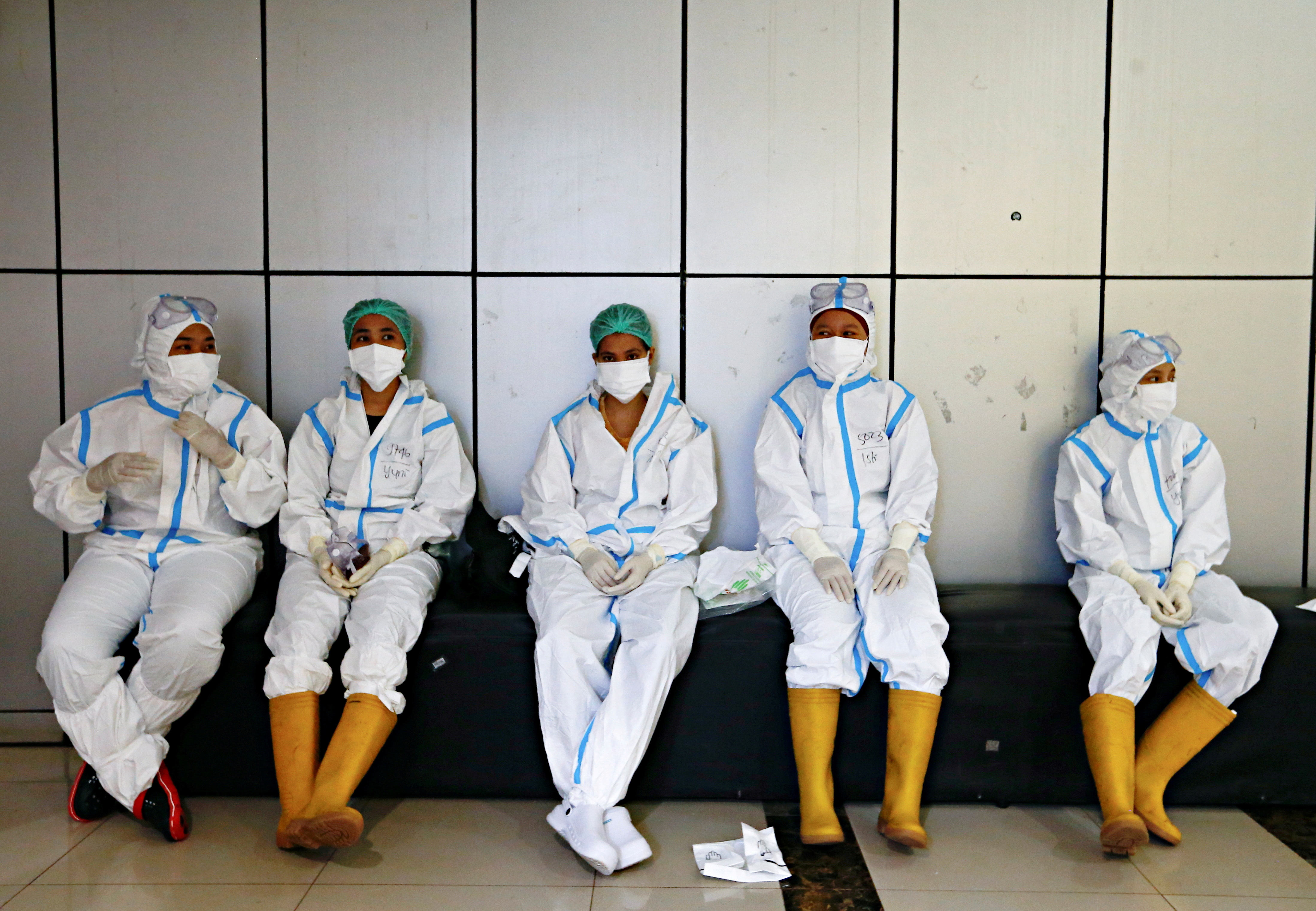 Healthcare workers wearing PPE get ready to treat patients at the emergency hospital for COVID-19, in Jakarta