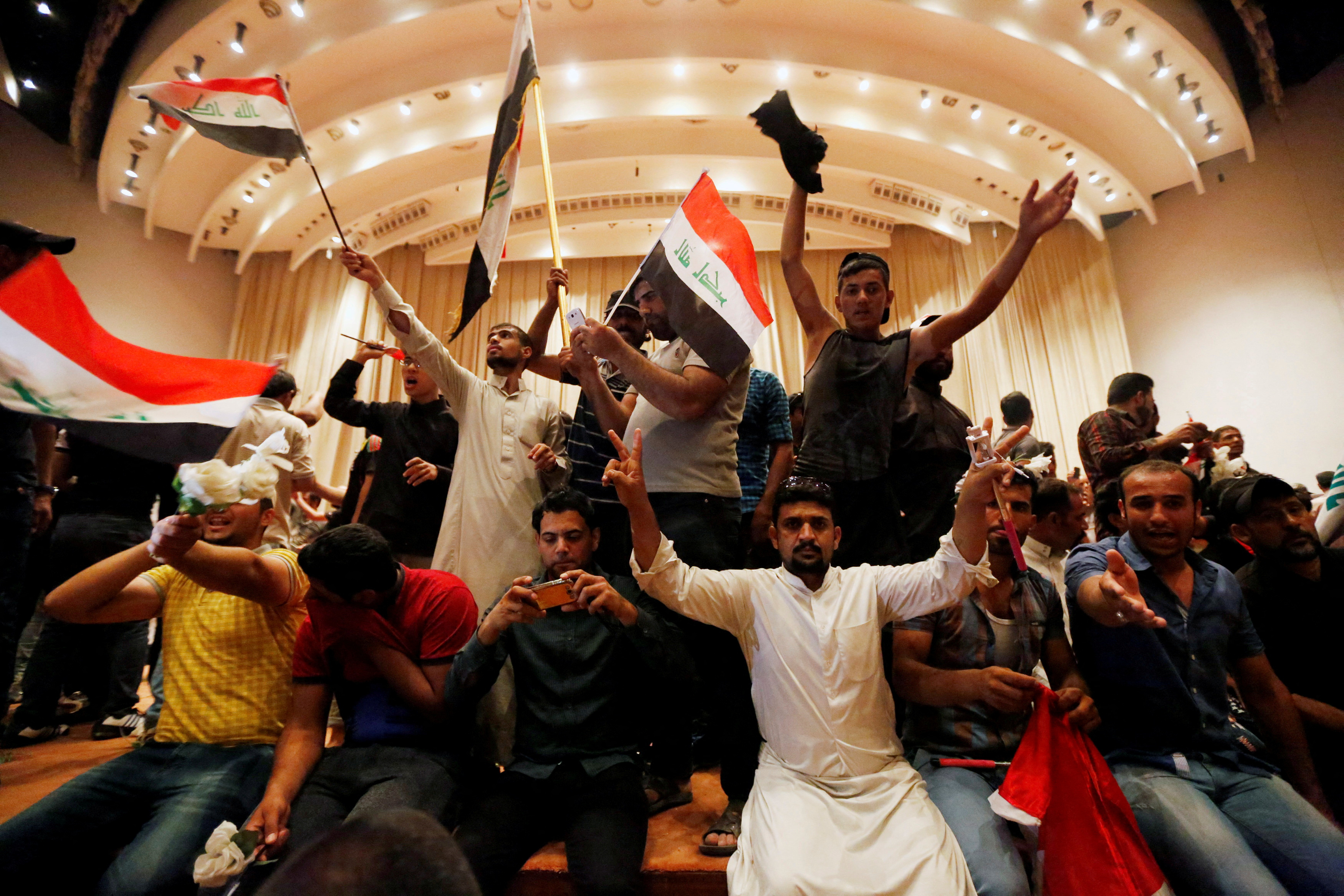 Followers of Iraq's Shi'ite cleric Moqtada al-Sadr are seen in the parliament building after they stormed Baghdad's Green Zone after lawmakers failed to convene for a vote on overhauling the government