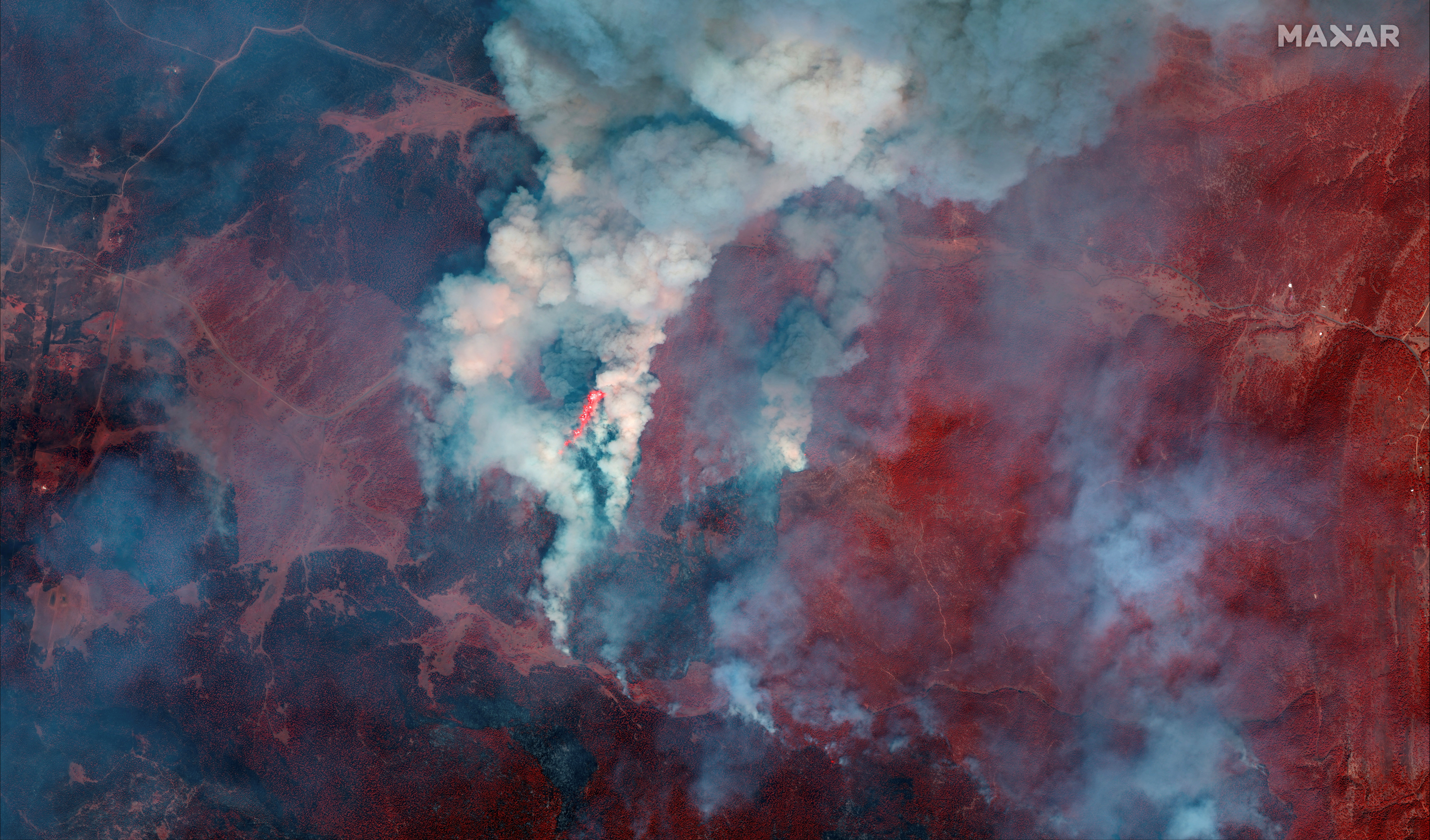A satellite image shows a color infrared view of fire lines during Hermits Peak wildfire, east of Santa Fe, New Mexico