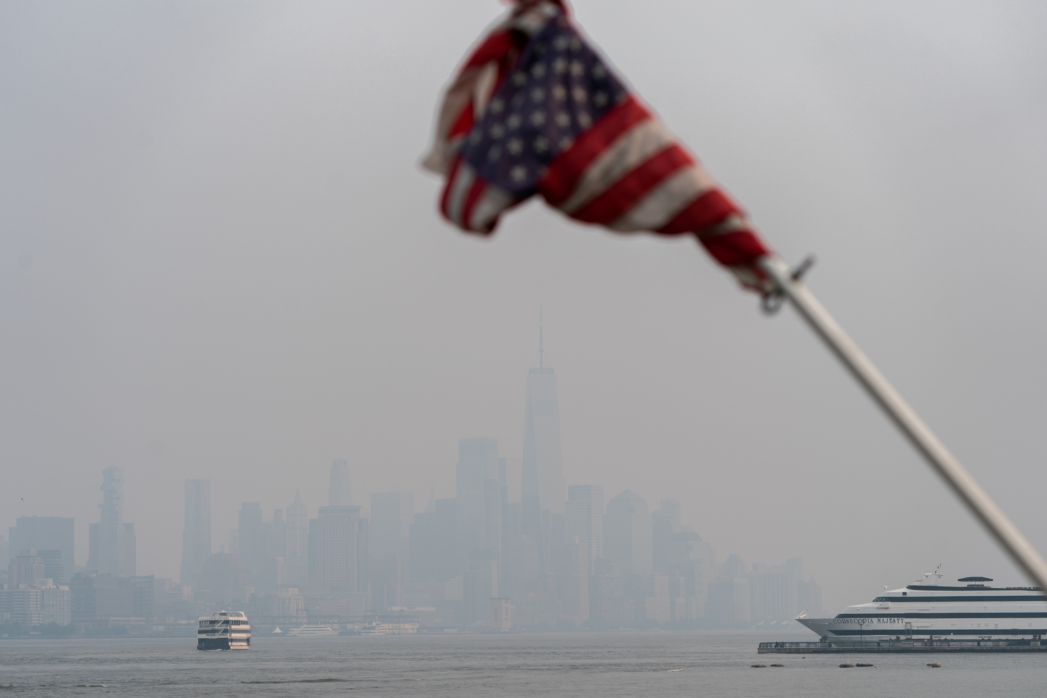 The New York City skyline is seen through a cover of wildfire smoke from Hoboken, New Jersey, U.S., July 20, 2021. REUTERS/Jeenah Moon 