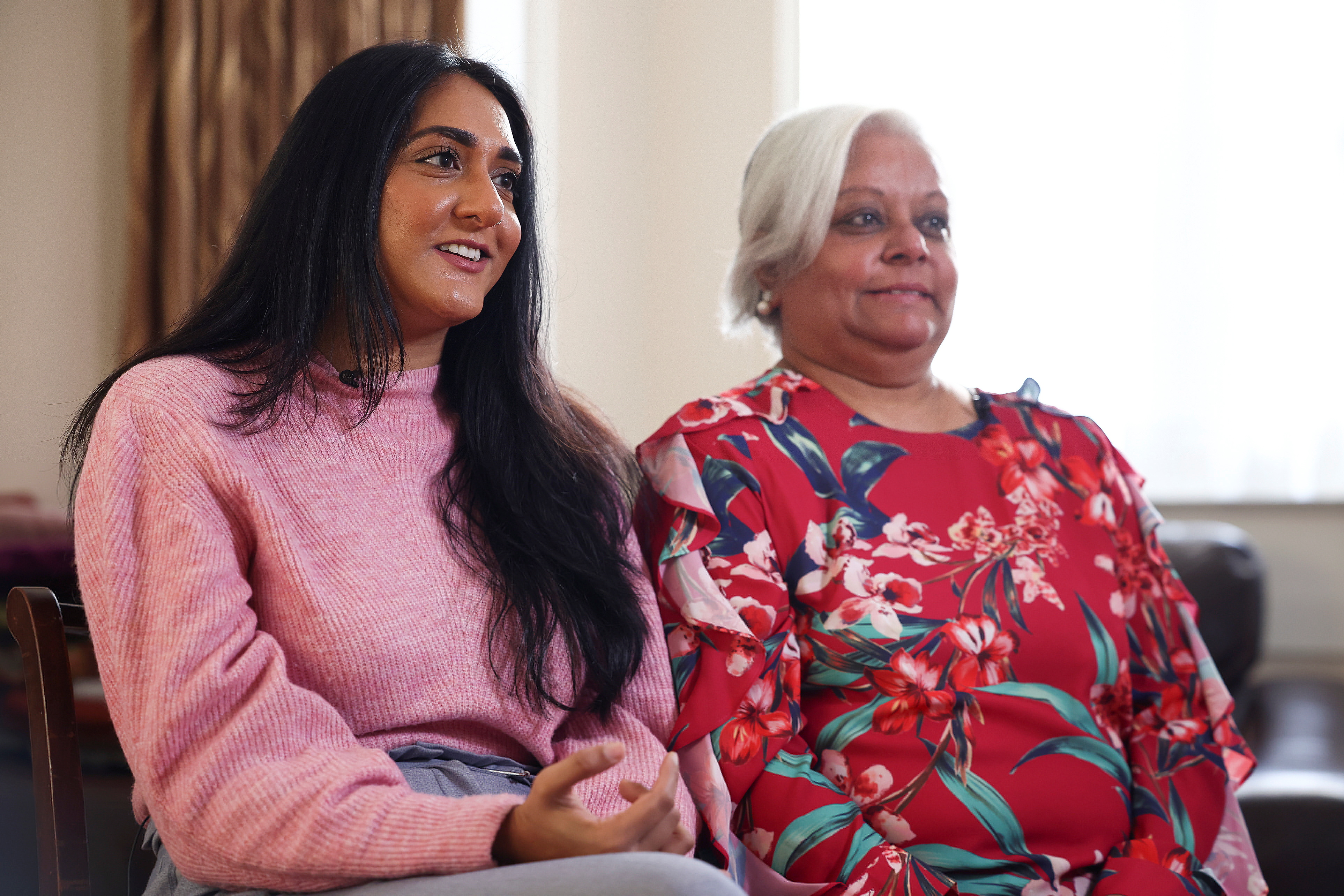 Bhavna Patel and her daughter Bindiya Patel, who are due to fly to New York to reunite with family following the relaxing of the coronavirus disease (COVID-19) travel restrictions, react during an interview with Reuters at their home in Croydon, Britain, November 5, 2021. REUTERS/Henry Nicholls
