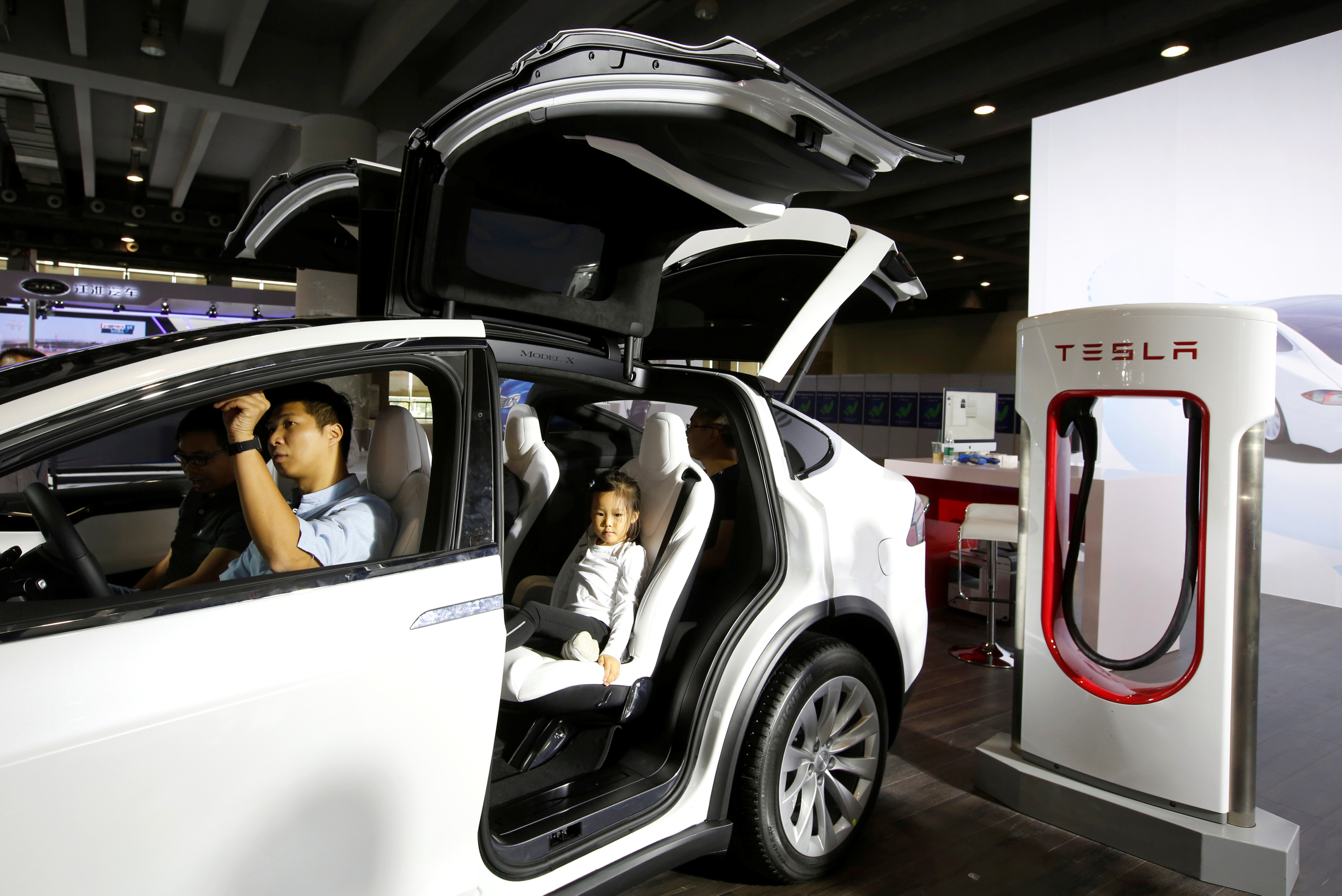 Visitors experience Tesla Model X at Auto Guangzhou in Guangzhou