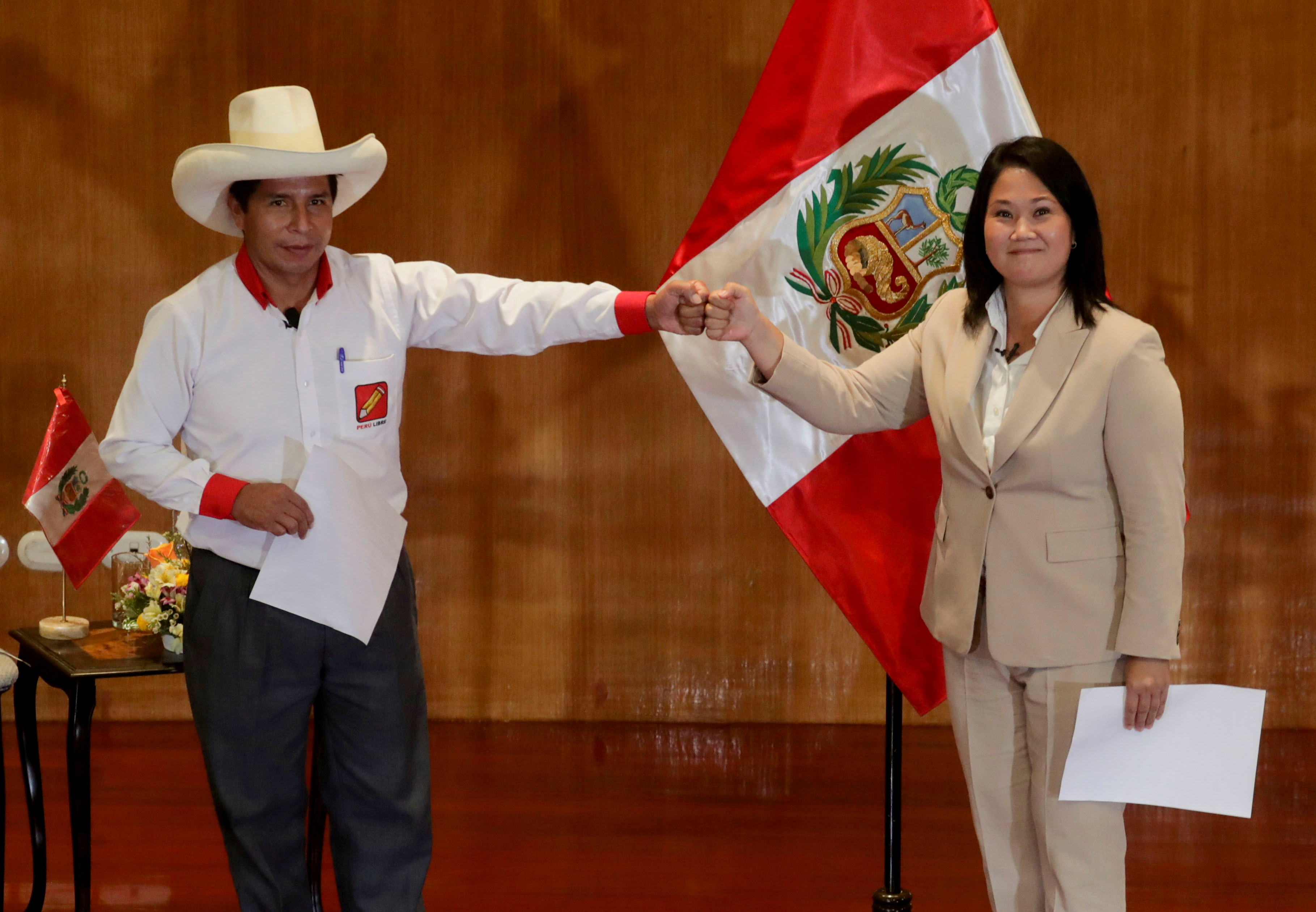 Peruvian presidential candidates Pedro Castillo and Keiko Fujimori, who will face each other in a run-off vote on June 6, gesture, in Lima