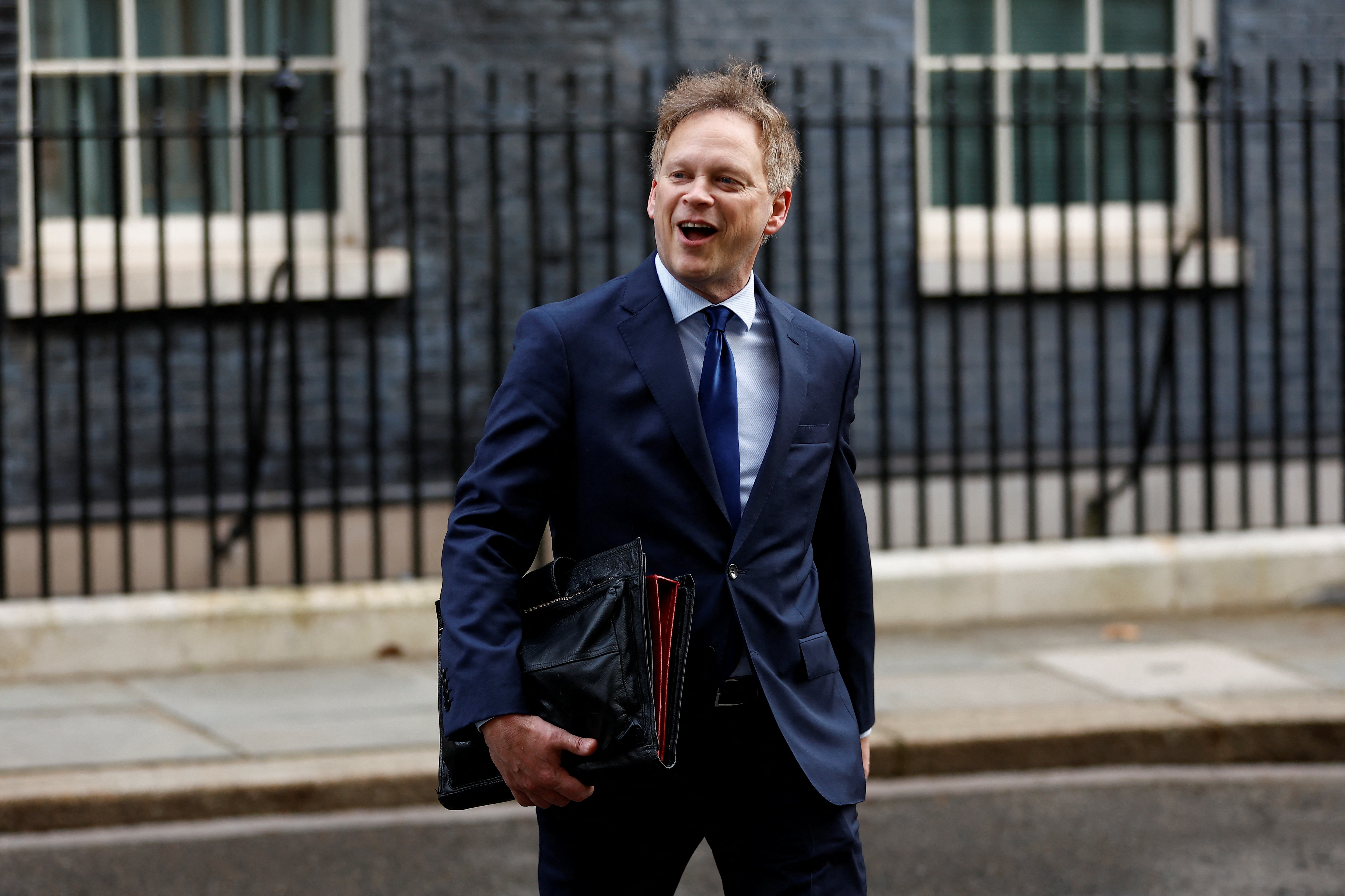 Britain's Member of Parliament Grant Shapps walks on Downing Street