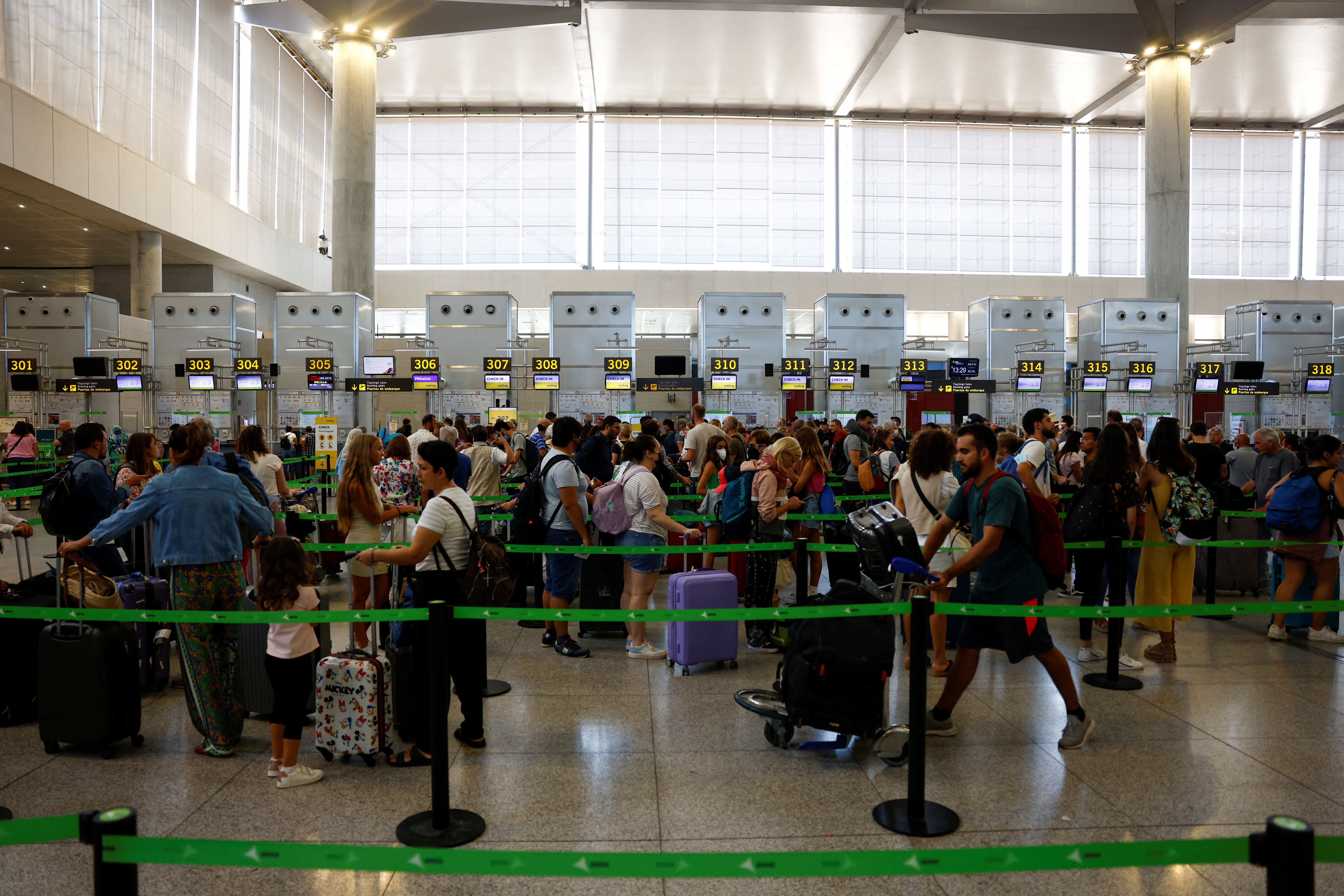 Vueling passengers queue at check-in desks at Malaga-Costa del Sol Airport in Malaga