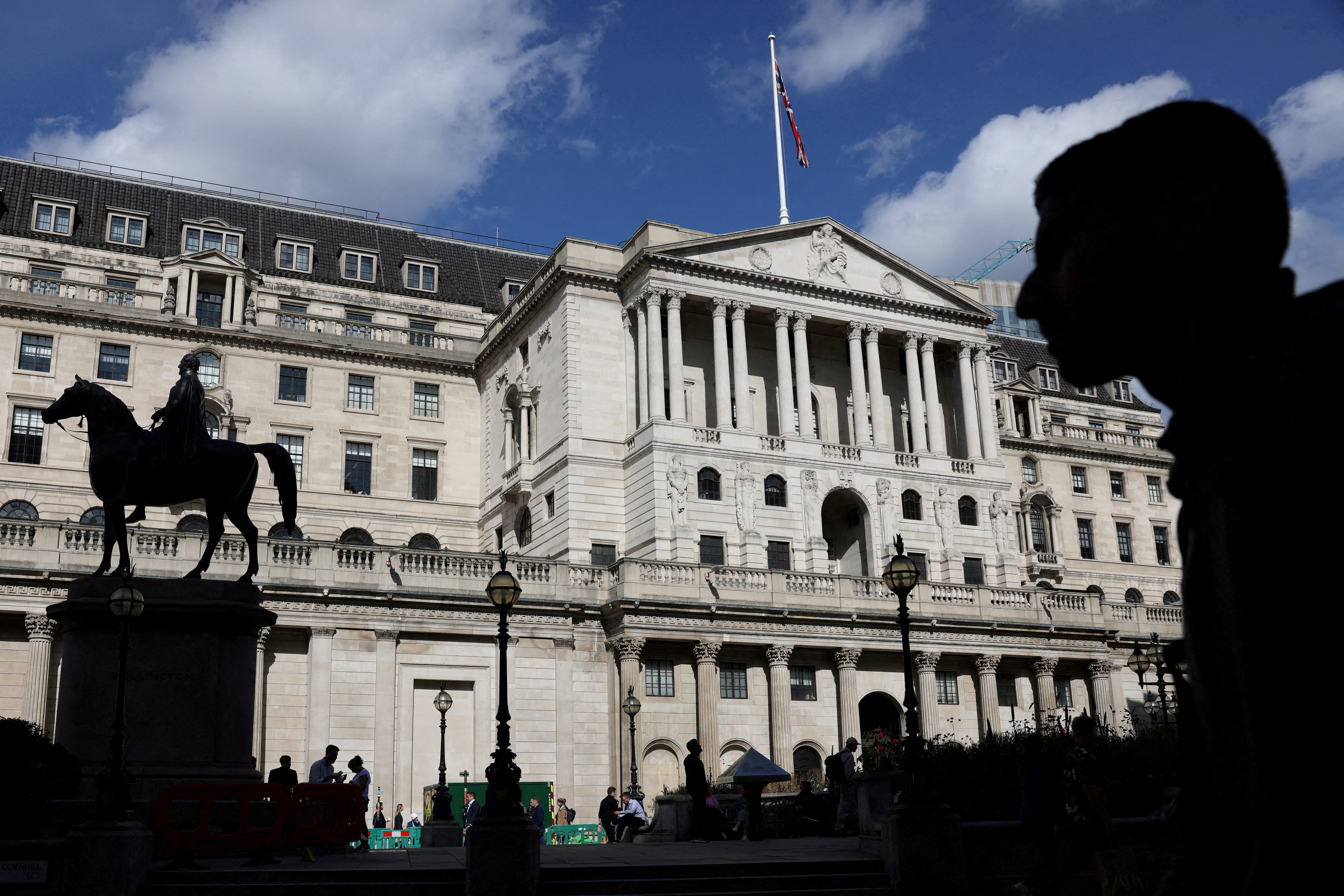 Pedestrian walks past the Bank of England in London