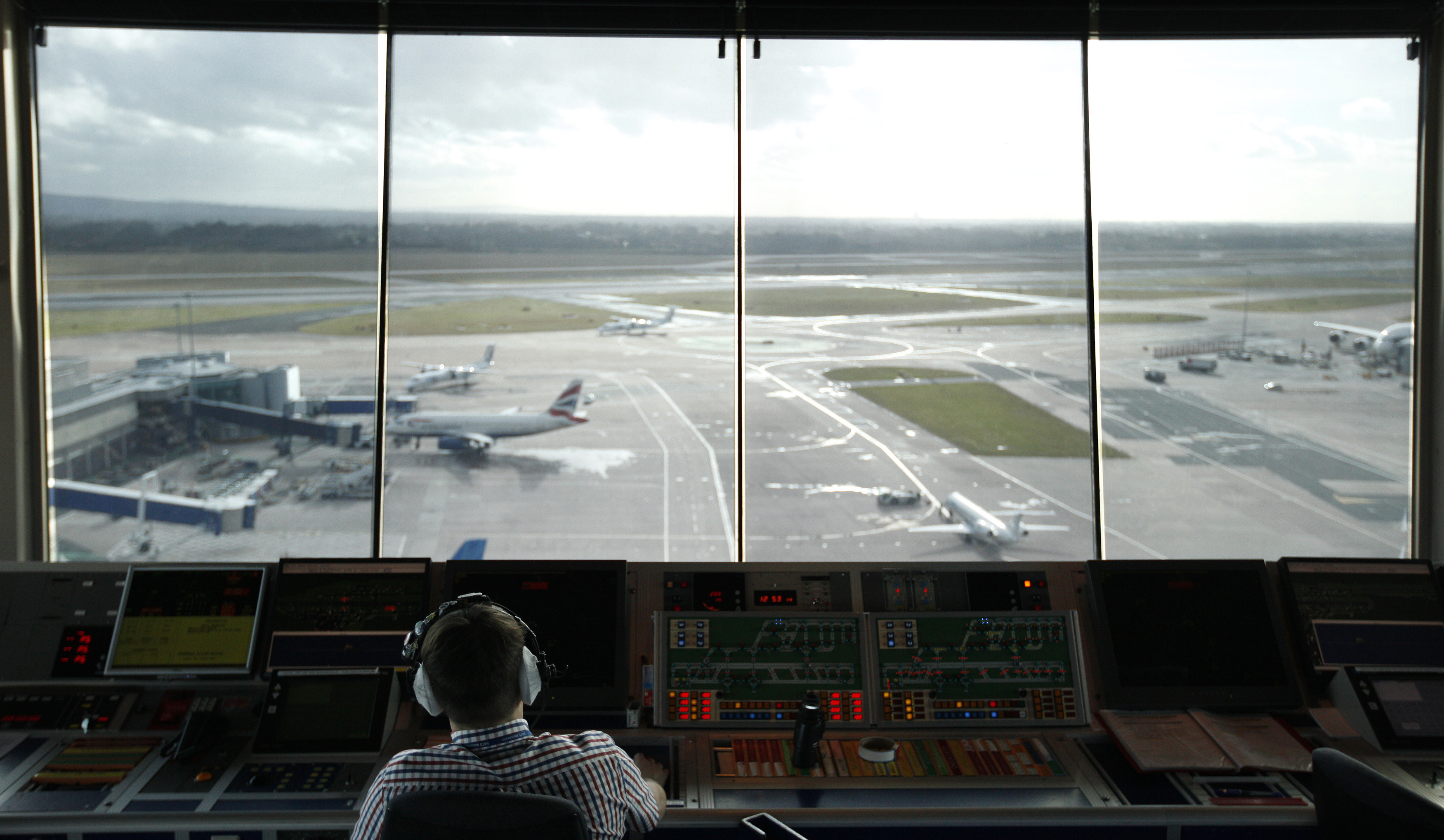 An air traffic controller monitors aircraft movement from the control tower at Manchester Airport