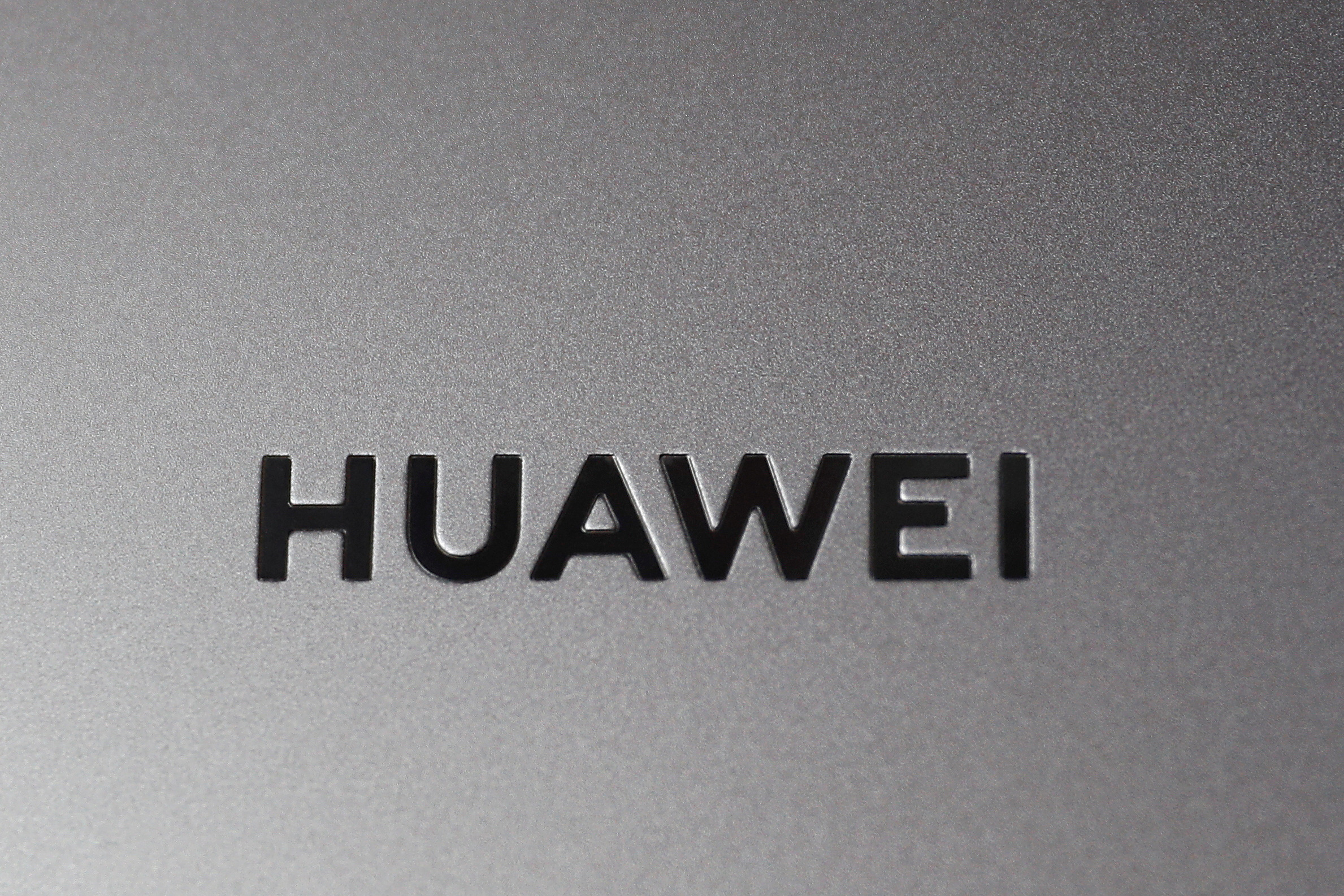 A Huawei logo is seen on a device at a media event in London