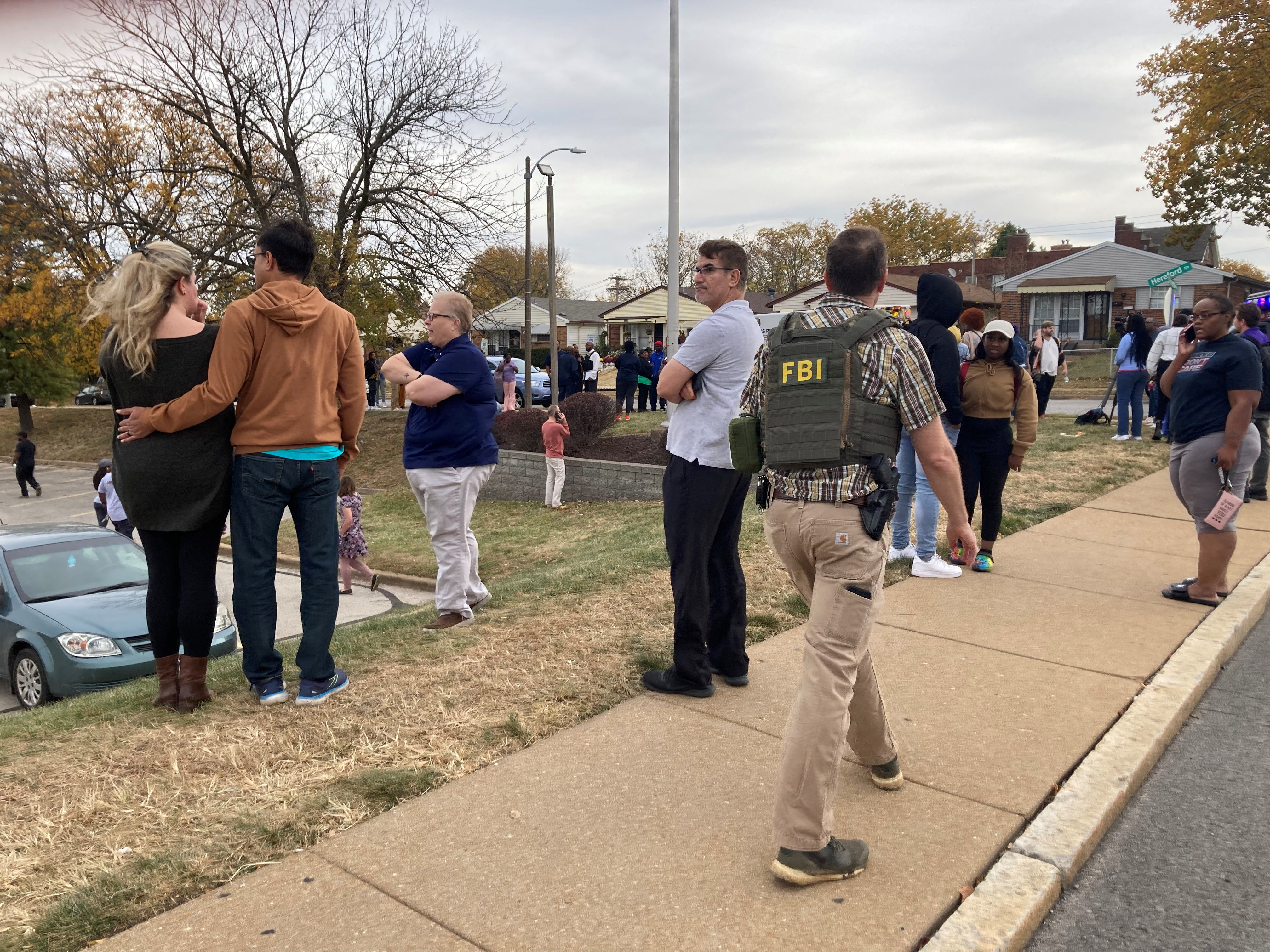FILE PHOTO - People gather following a shooting at a high school, in St. Louis