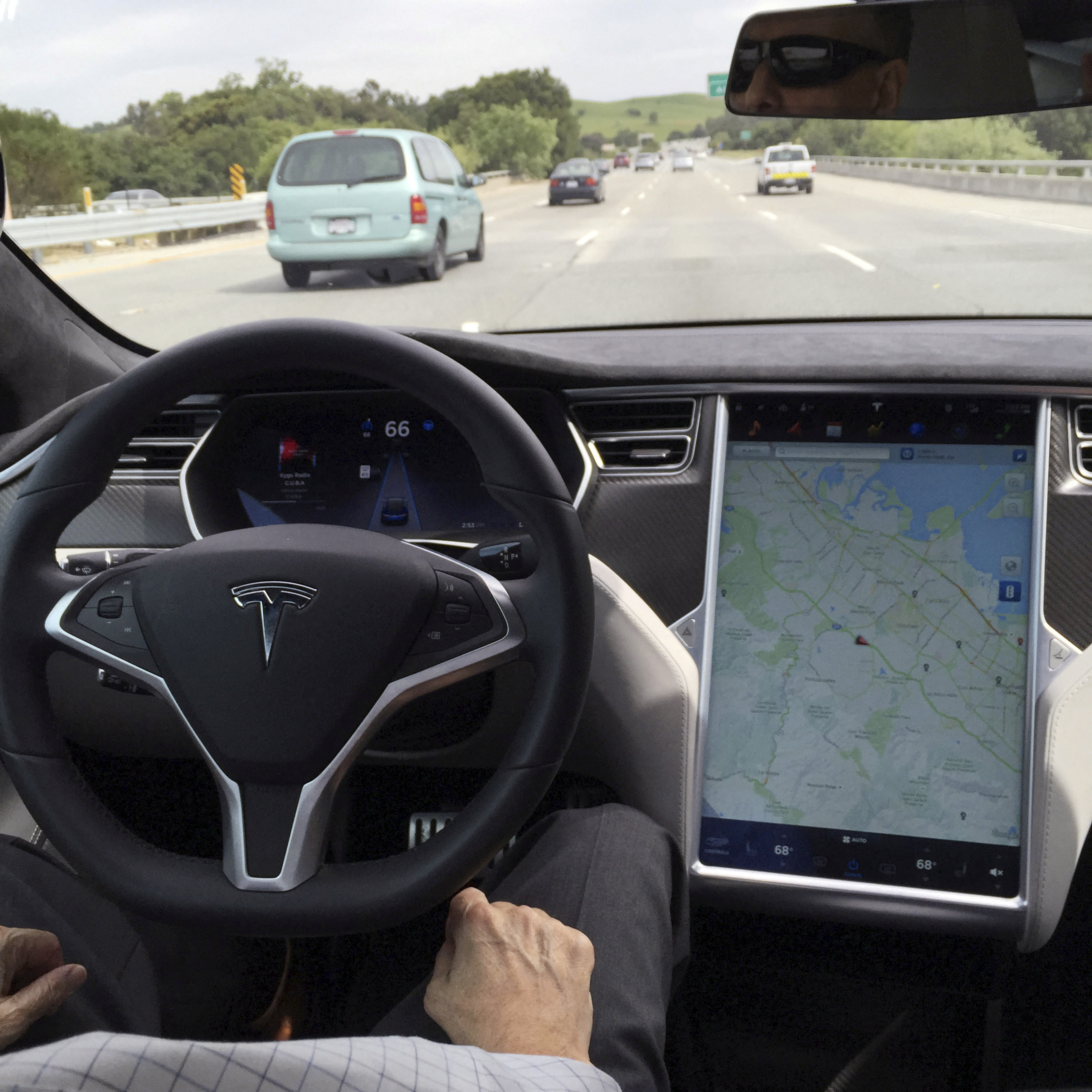 The interior of a Tesla Model S is shown in autopilot mode in San Francisco.
