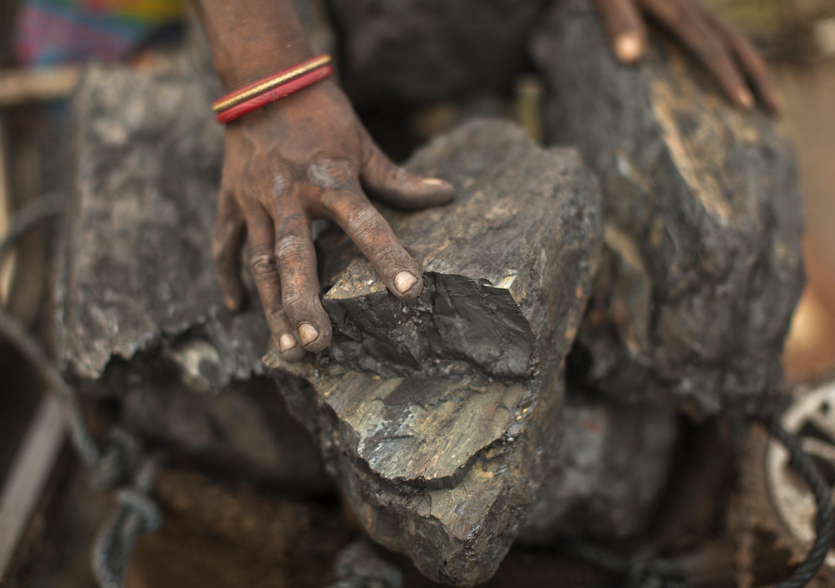 A local woman prepares to carry coal at an open coal field at Dhanbad district in Jharkhand