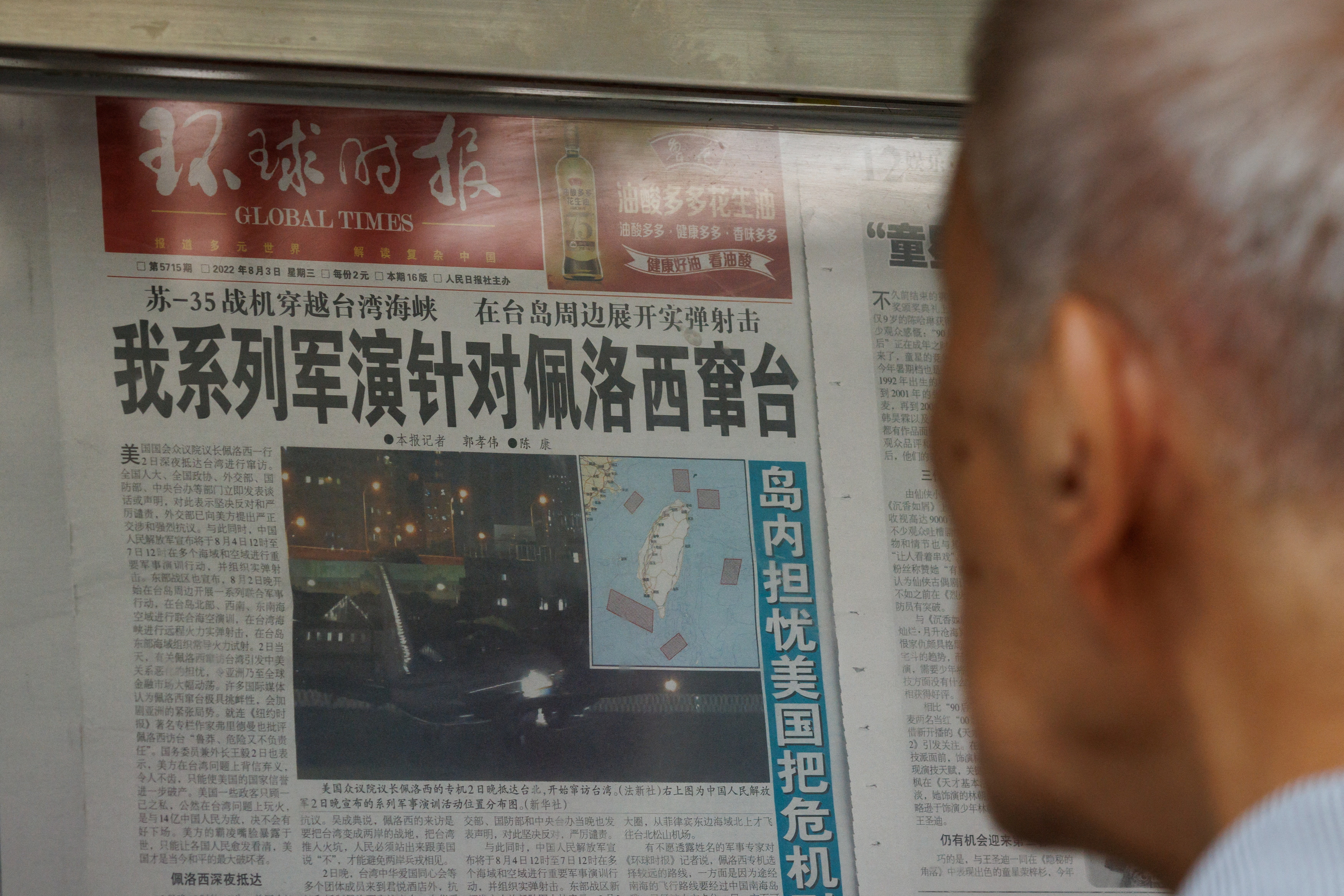 A man reads a Global Times article about military exercises by the Chinese People's Liberation Army (PLA) following U.S. House of Representatives Speaker Pelosi's Taiwan visit, at a newspaper stand in Beijing