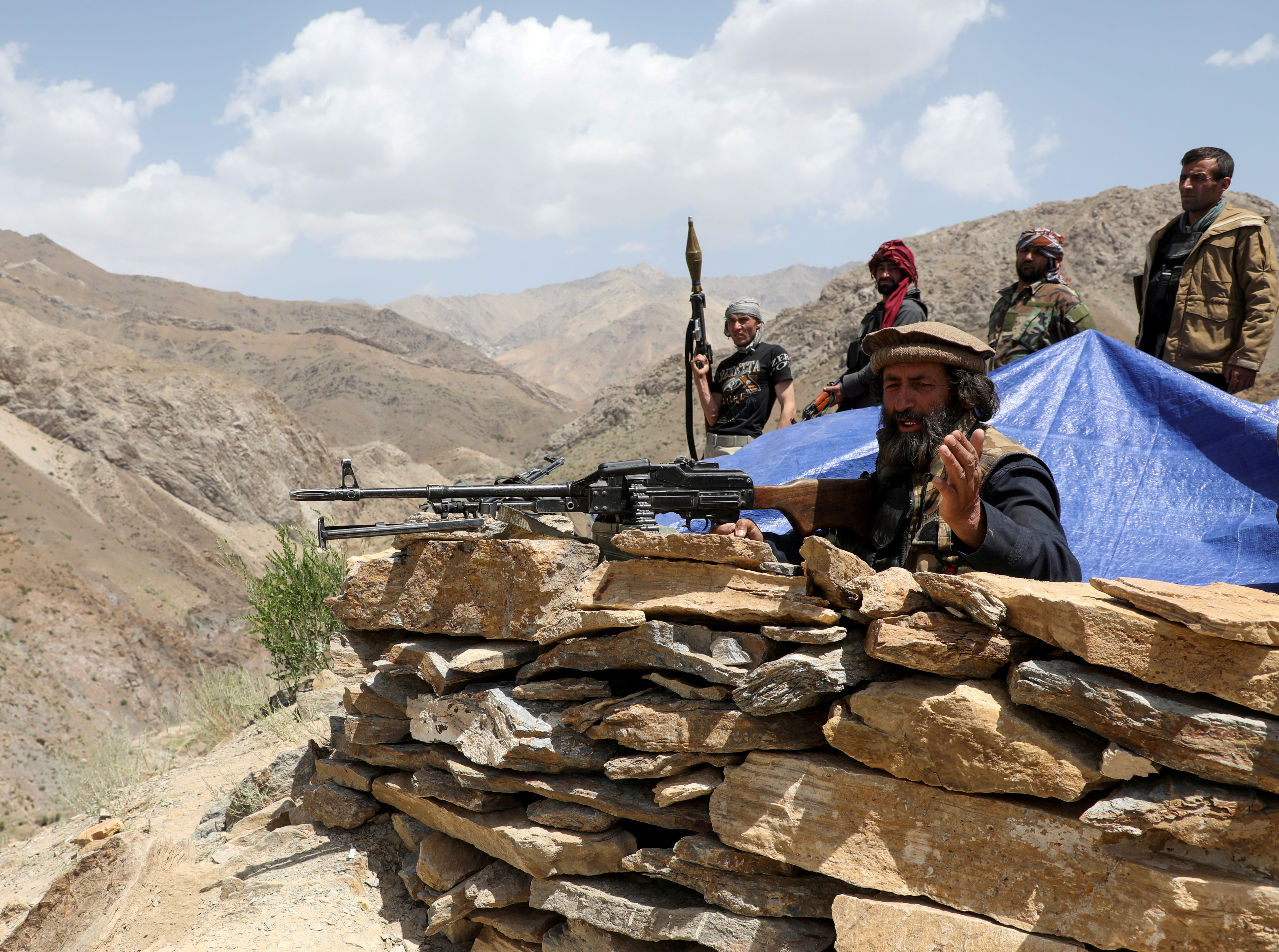 Armed men who are against Taliban uprising stand at their check post, at the Ghorband District