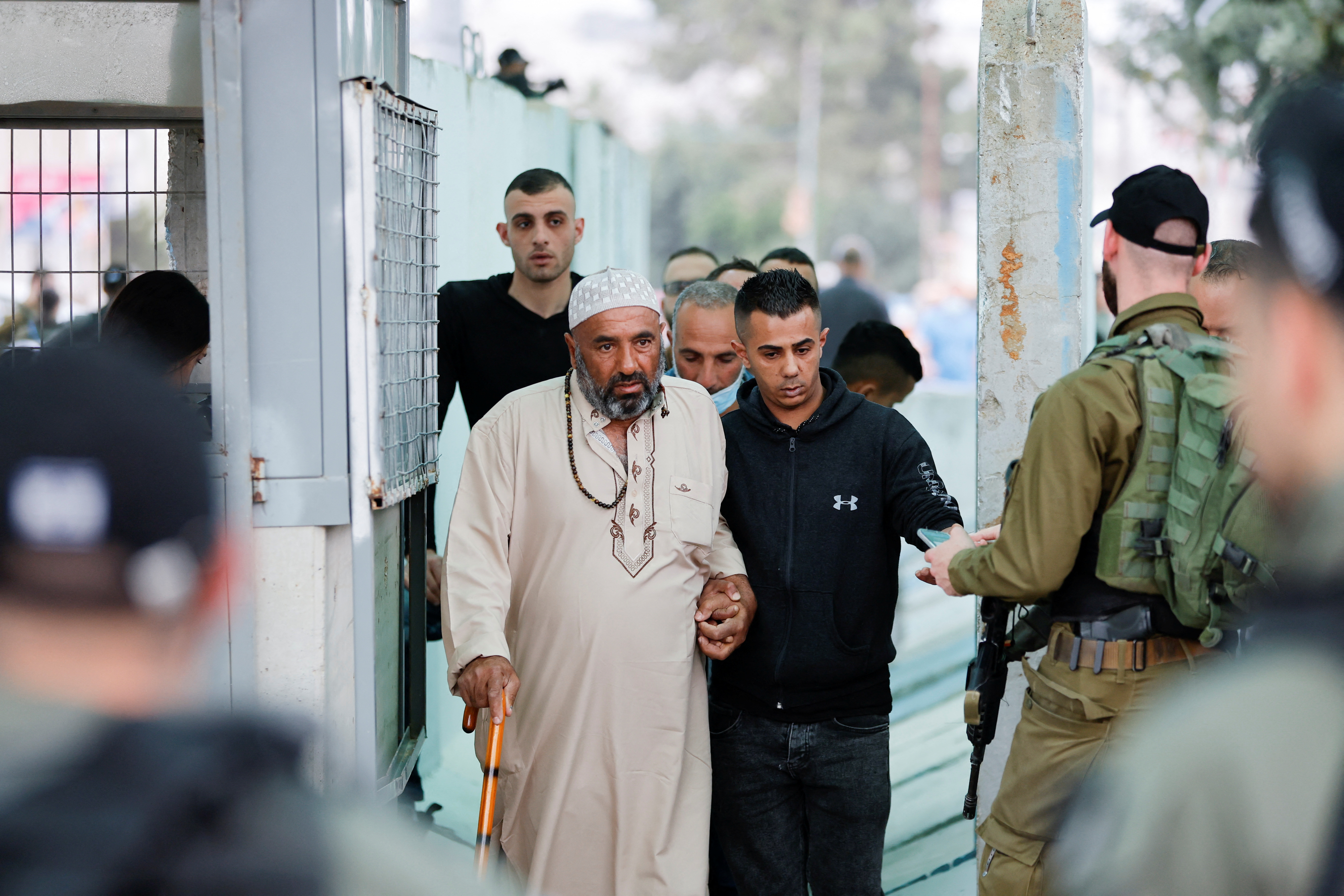 Palestinians make their way through an Israeli checkpoint to attend the first Friday prayers of Ramadan in Jerusalem's Al-Aqsa mosque, in Bethlehem in the Israeli-occupied West Bank