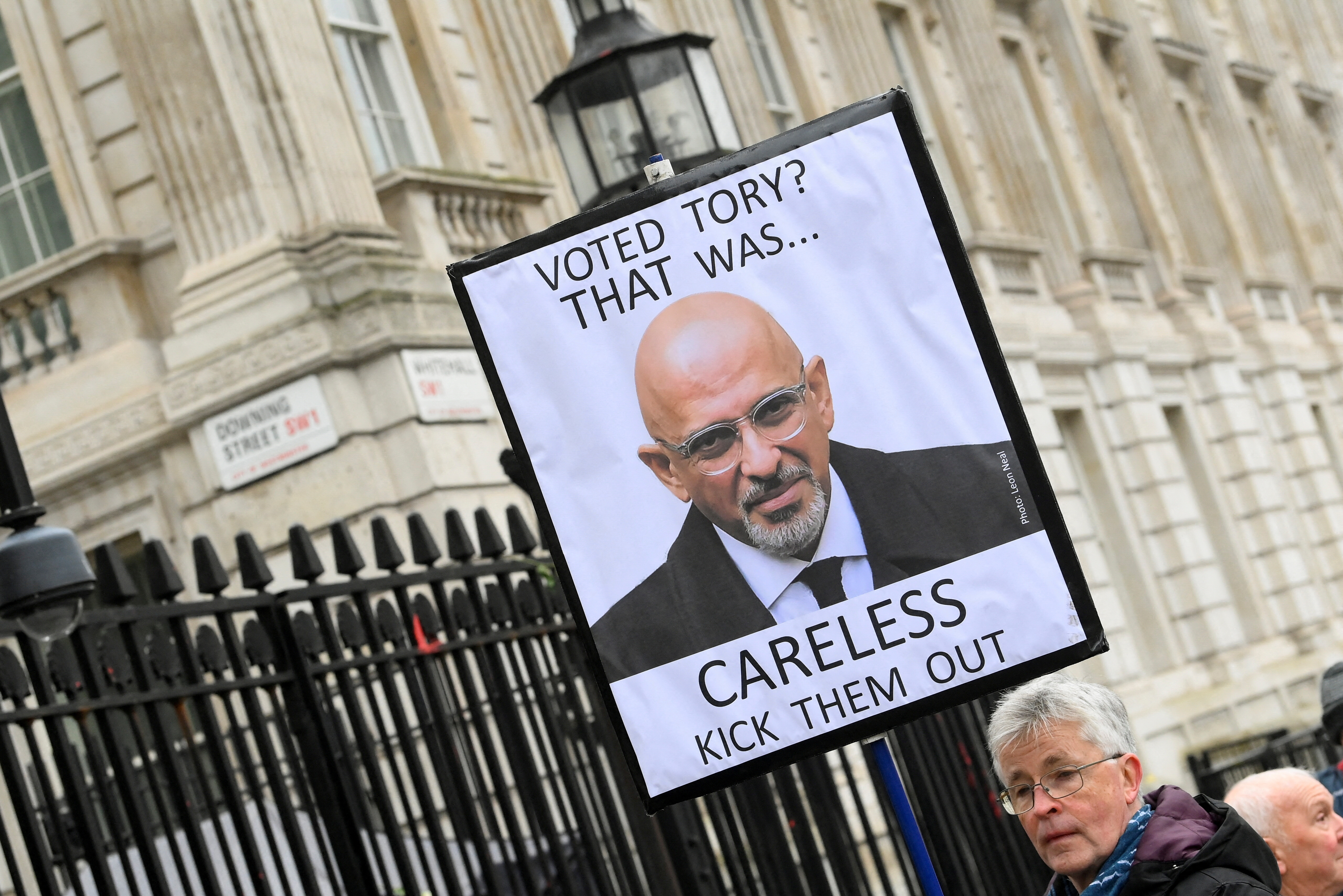 A protester stands outside Number 10 Downing Street, in London