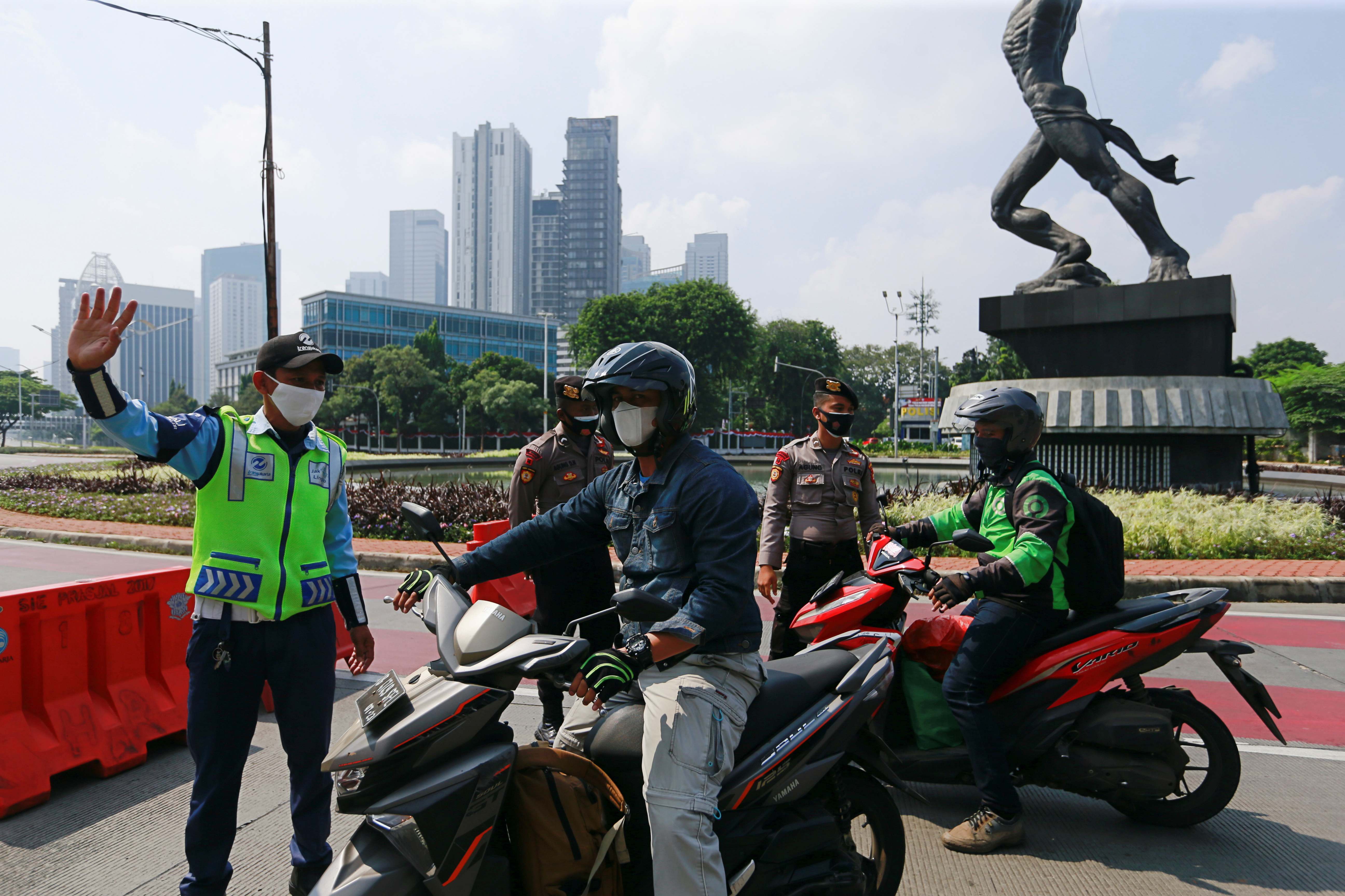 Officials stop motorbikes while enforcing large-scale social restrictions to prevent the spread of coronavirus disease (COVID-19)