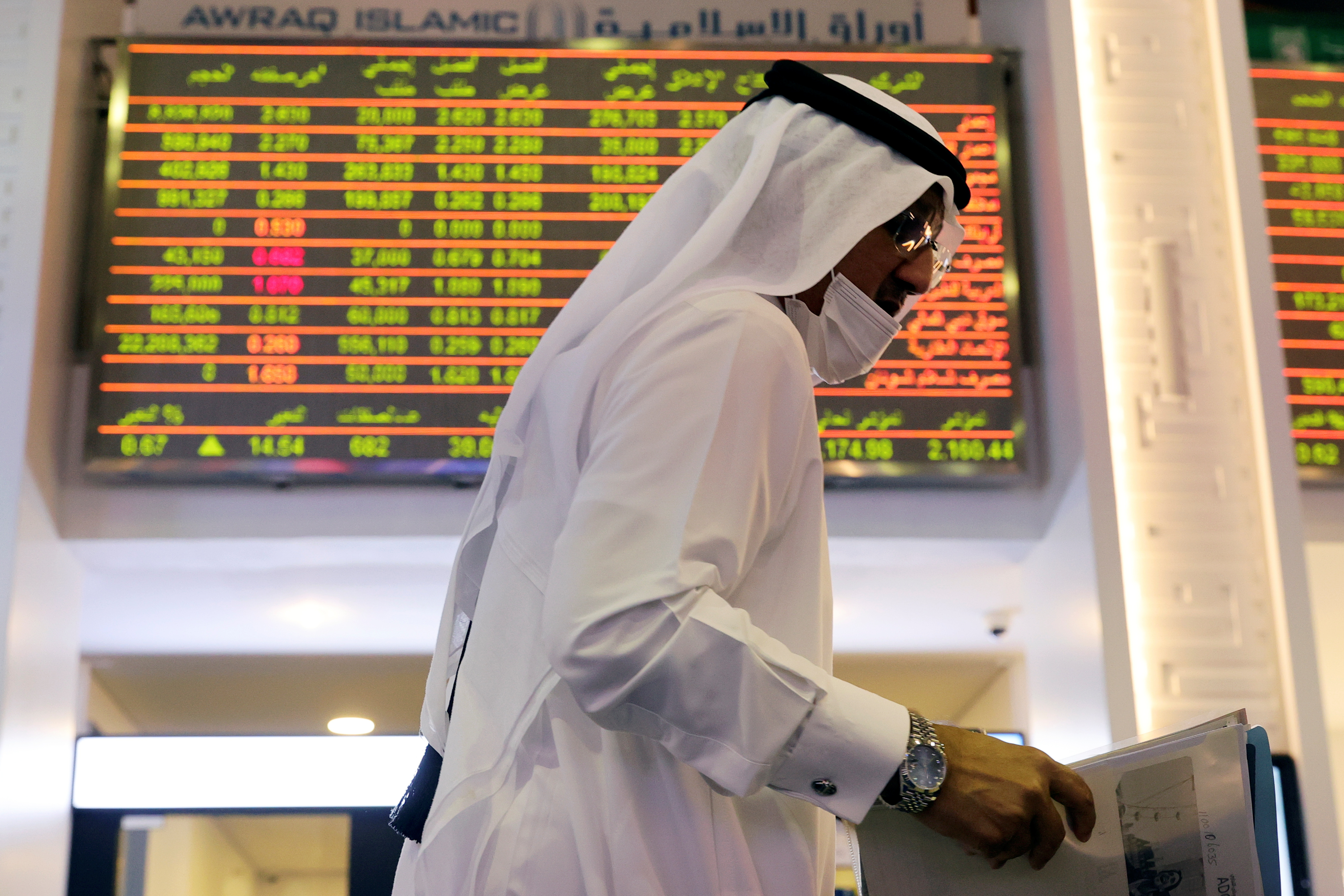 An investor walks through the Dubai Financial Market in Dubai