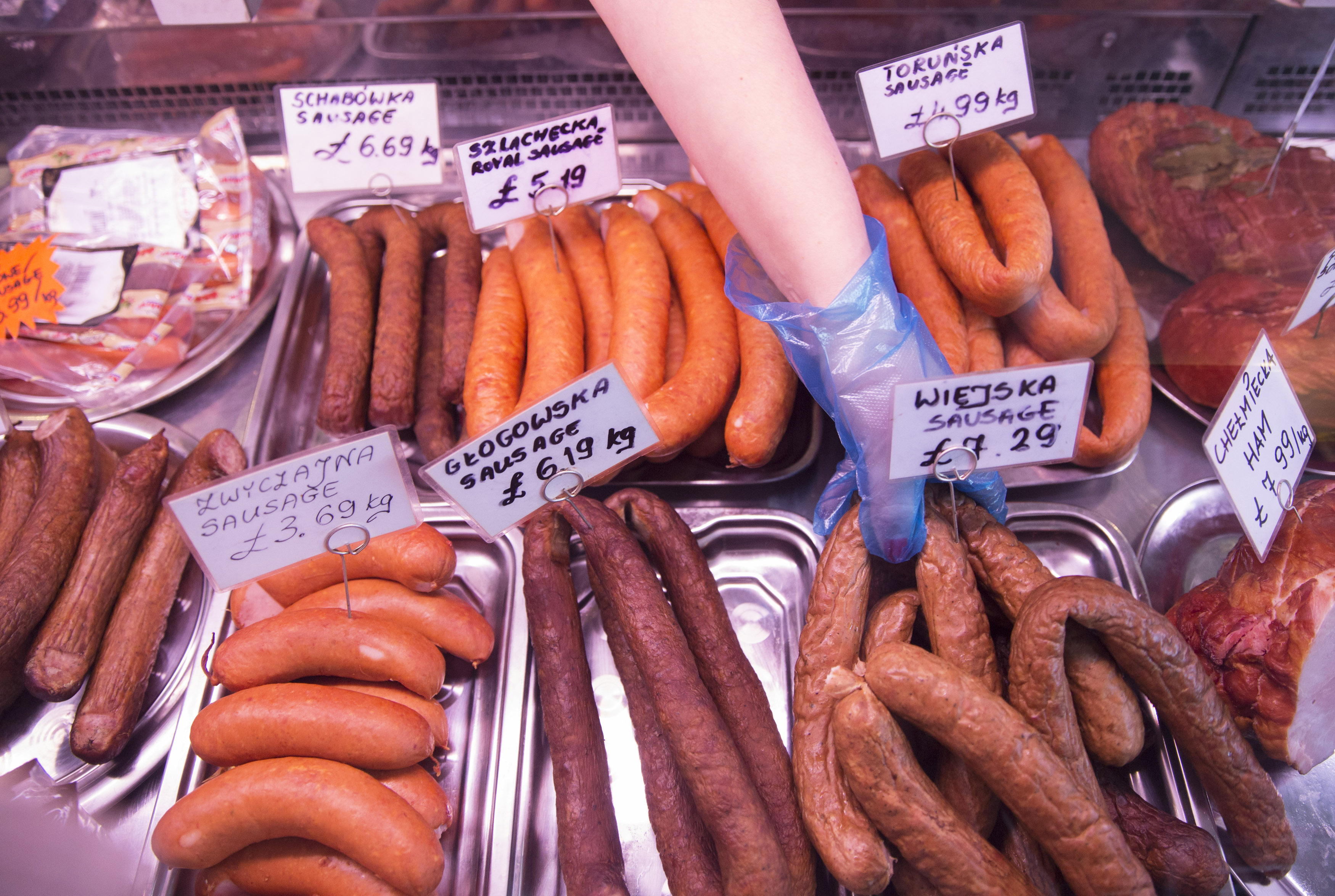 A worker reaches for sausage at a Polish delicatessen in Grays in southern Britain