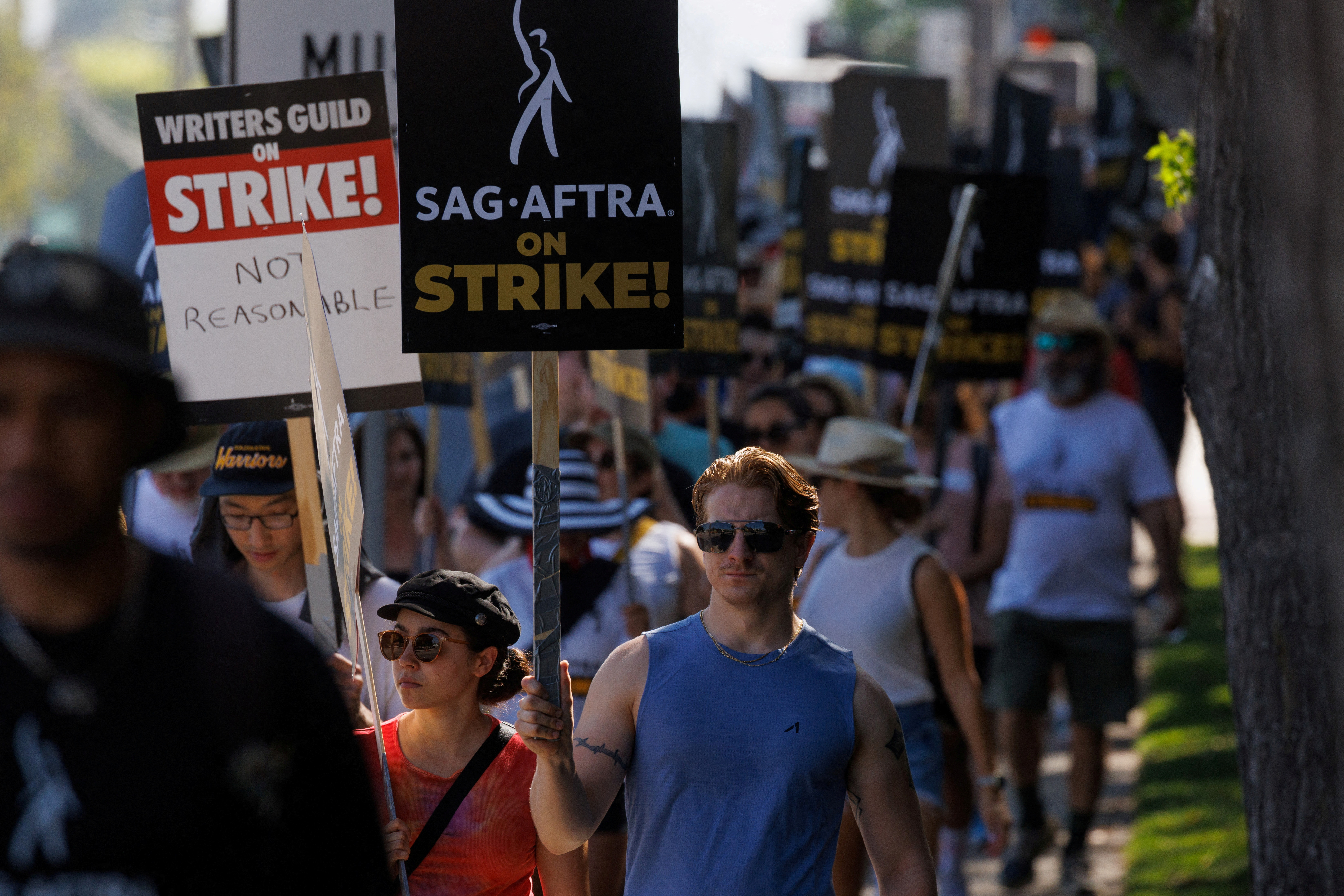 Hollywood actors and writers are on strike outside Disney Studios in California