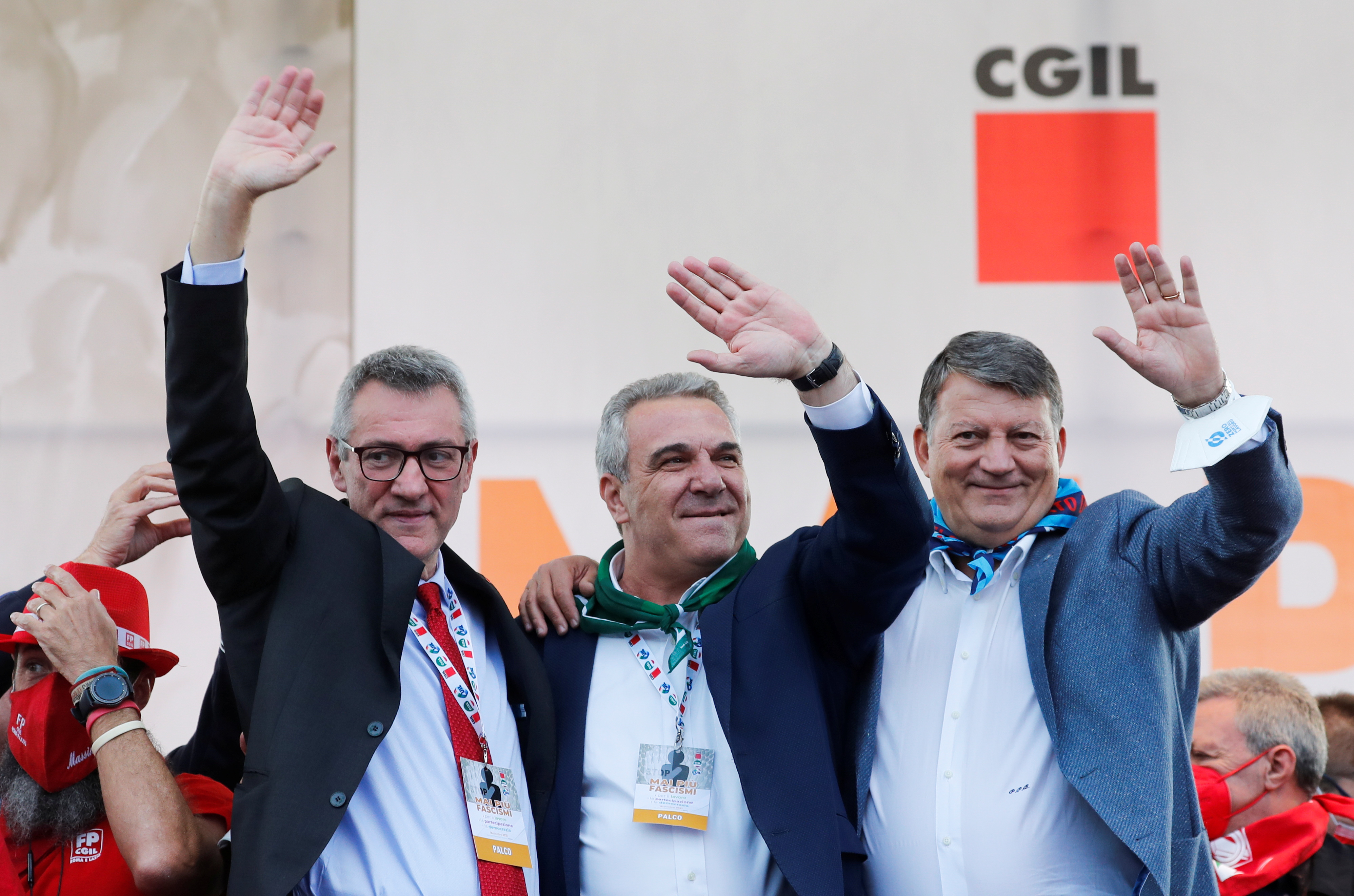 Union leaders Maurizio Landini, Luigi Sbarra and Pierpaolo Bombardieri wave during a protest against fascism a week after anti-vaccine riots by protesters including members of the far-right party Forza Nuova, in Rome, Italy, October 16, 2021. REUTERS/Remo Casilli