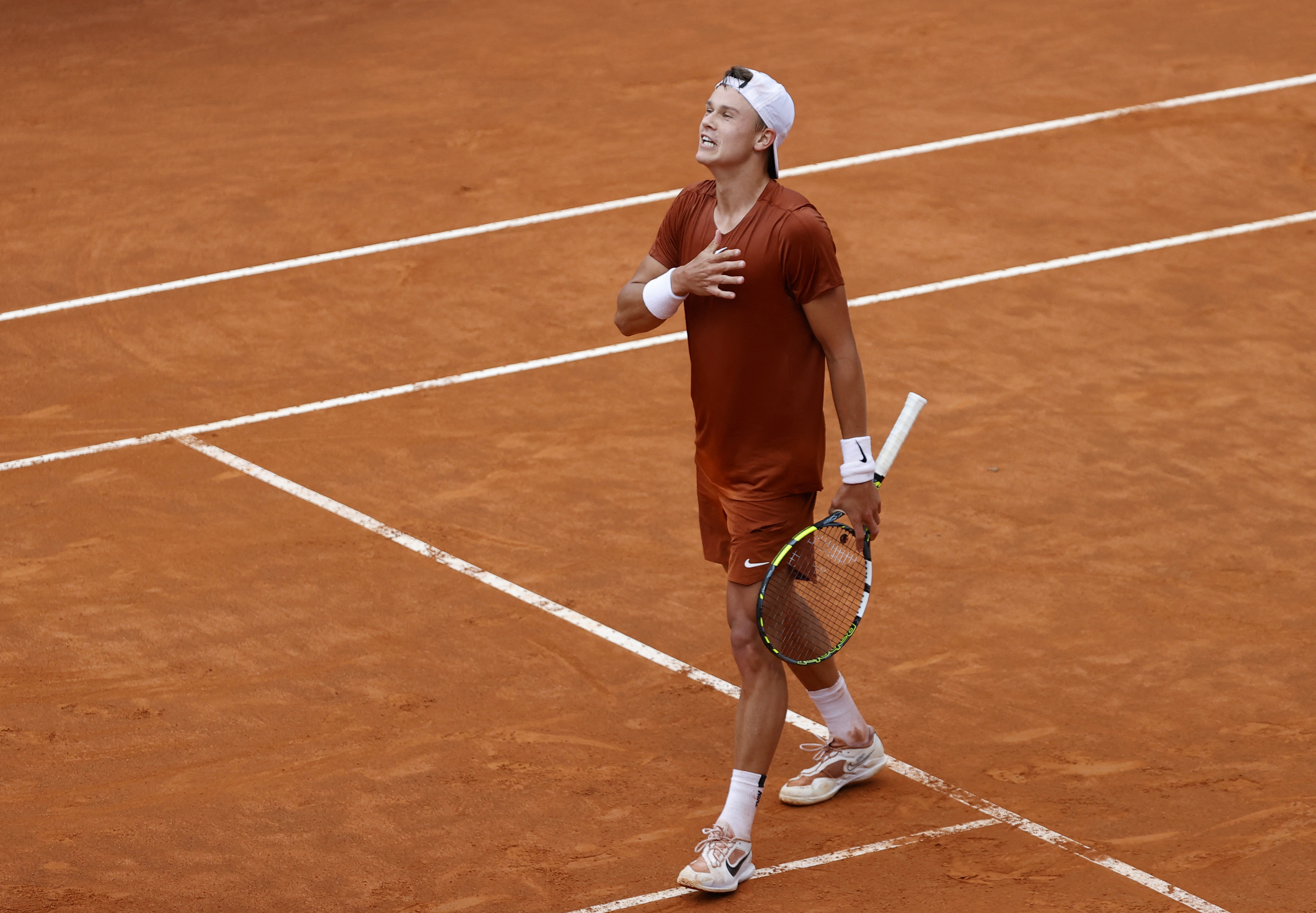 Rune upsets Djokovic to storm into Rome semi-finals, injured Swiatek  retires