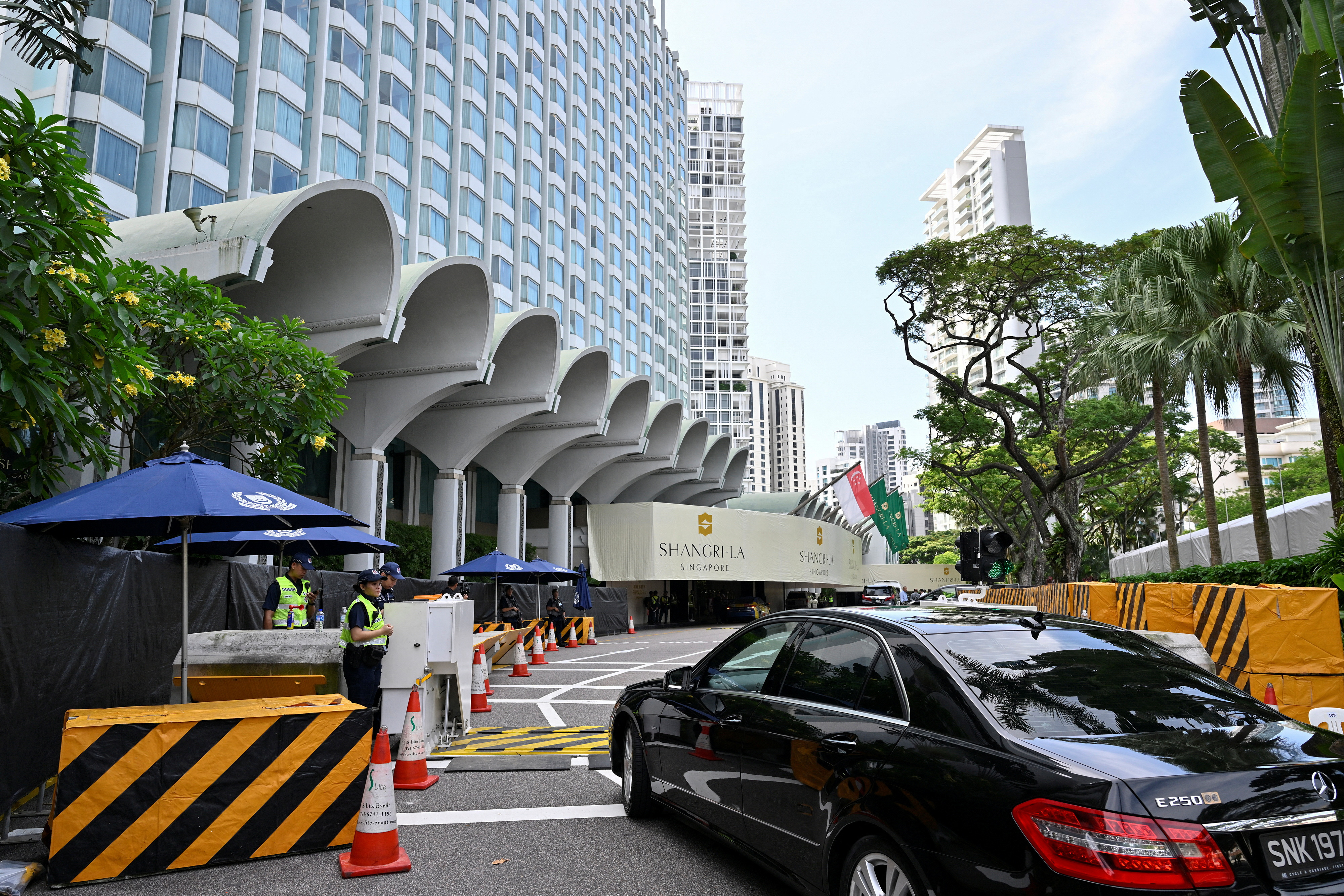 Security personnel check vehicles entering the venue of the 20th Shangri-La Dialogue in Singapore