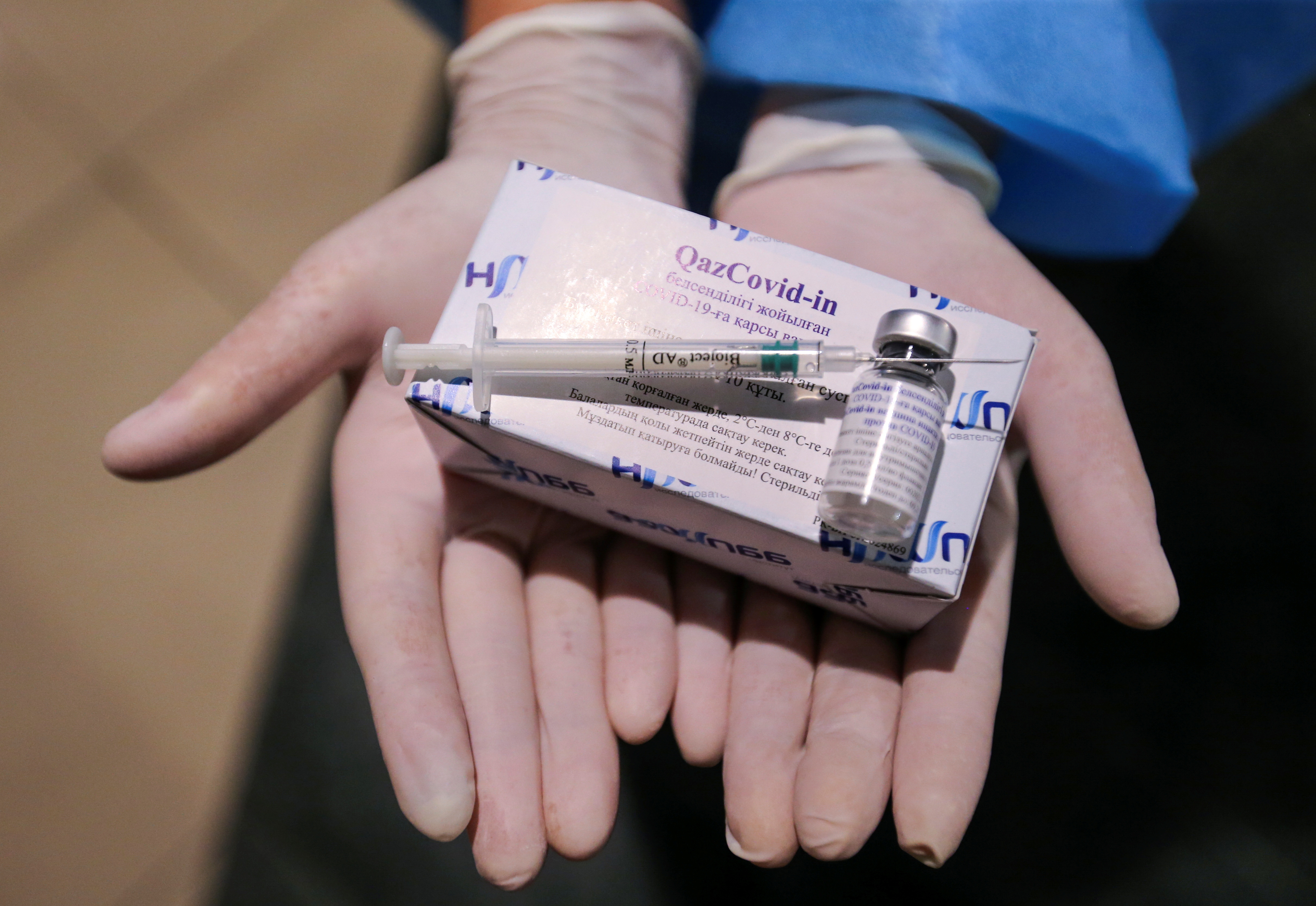 A medical worker shows the QazCovid-in vaccine in Almaty