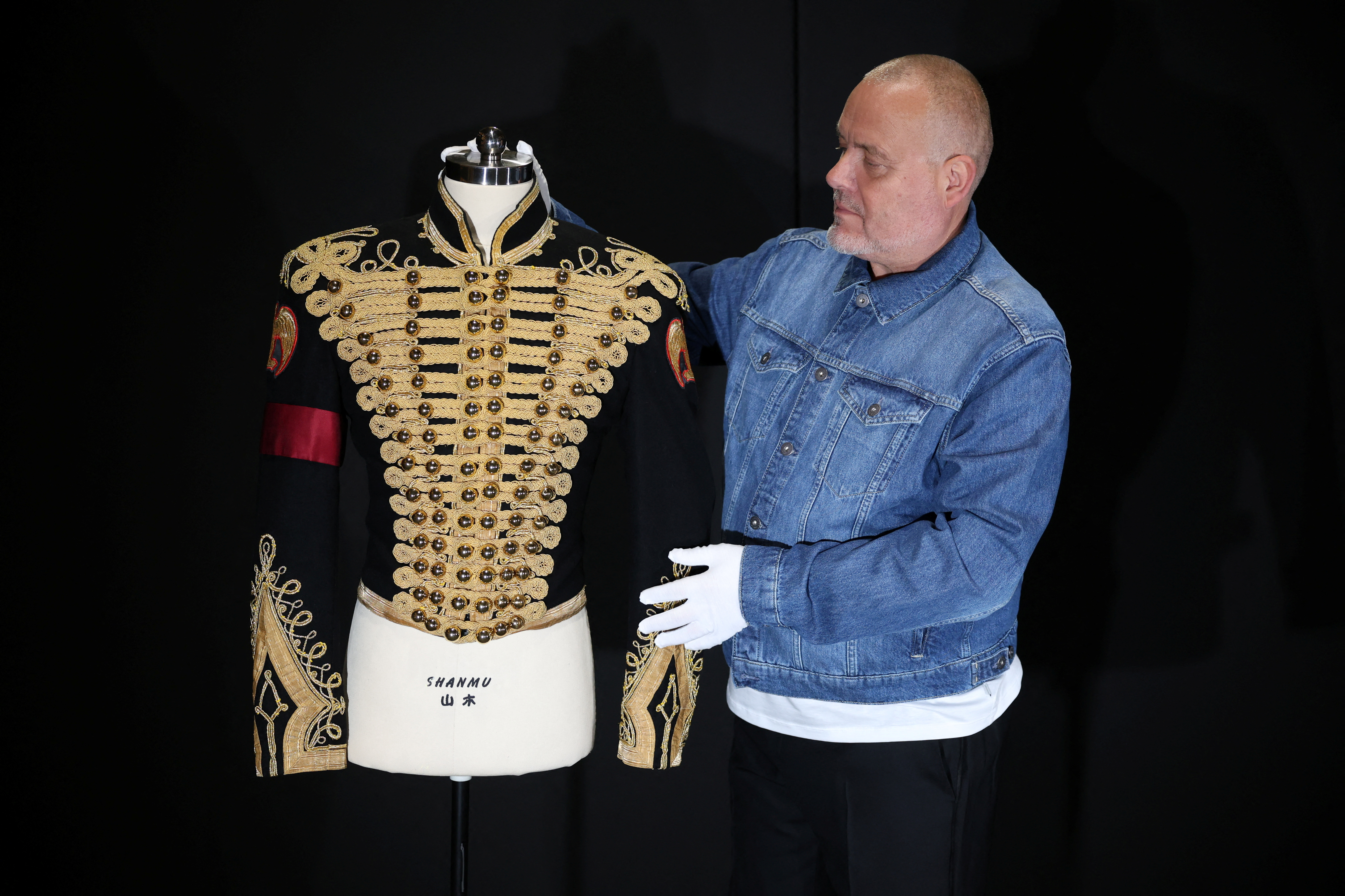 Director of music Mark Hochman poses with Michael Jackson’s Tour Rehearsal "Thriller" Jacket, at Propstore in Chenies