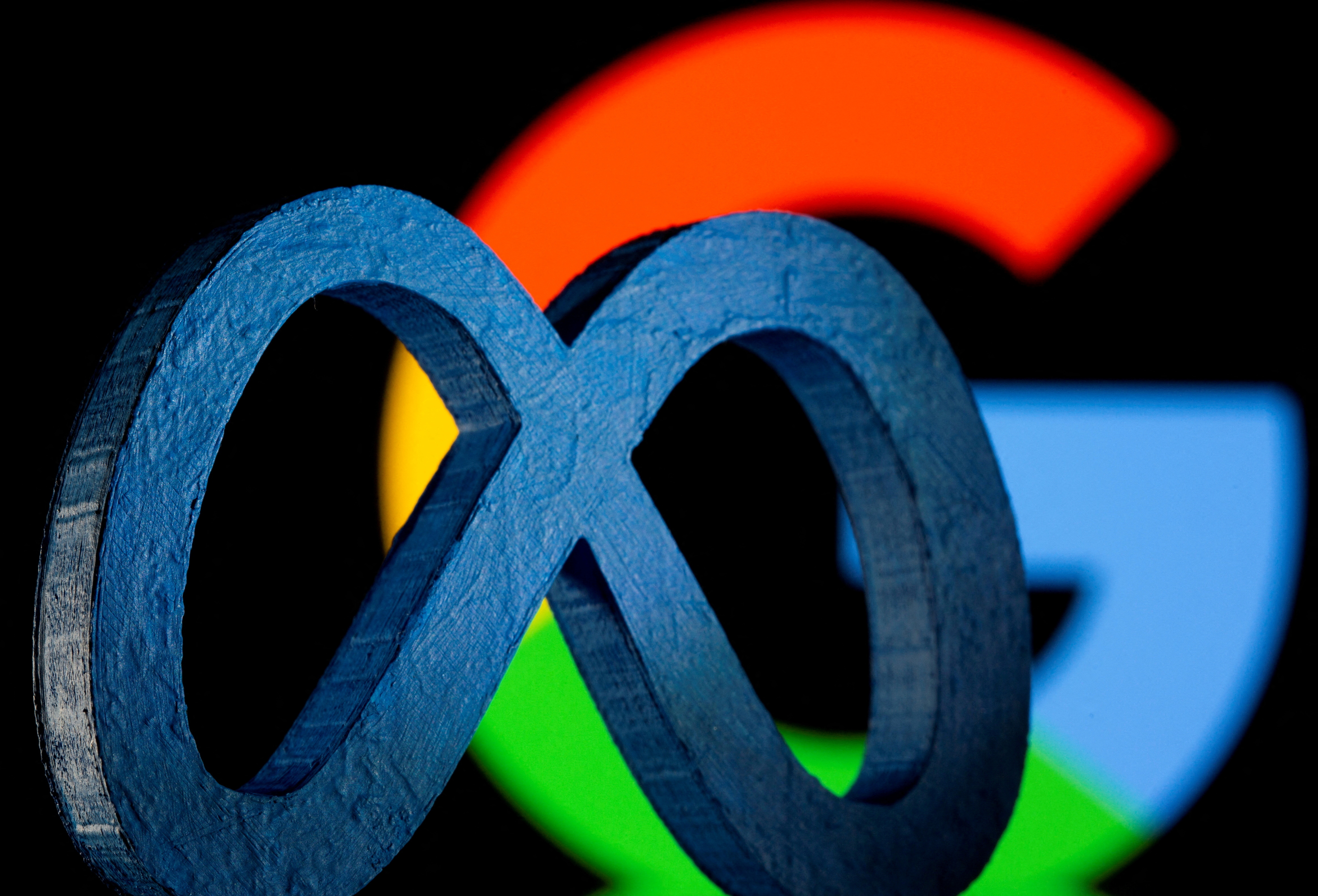 A 3D printed logo of Meta Platforms is seen in front of displayed Google logo in this illustration
