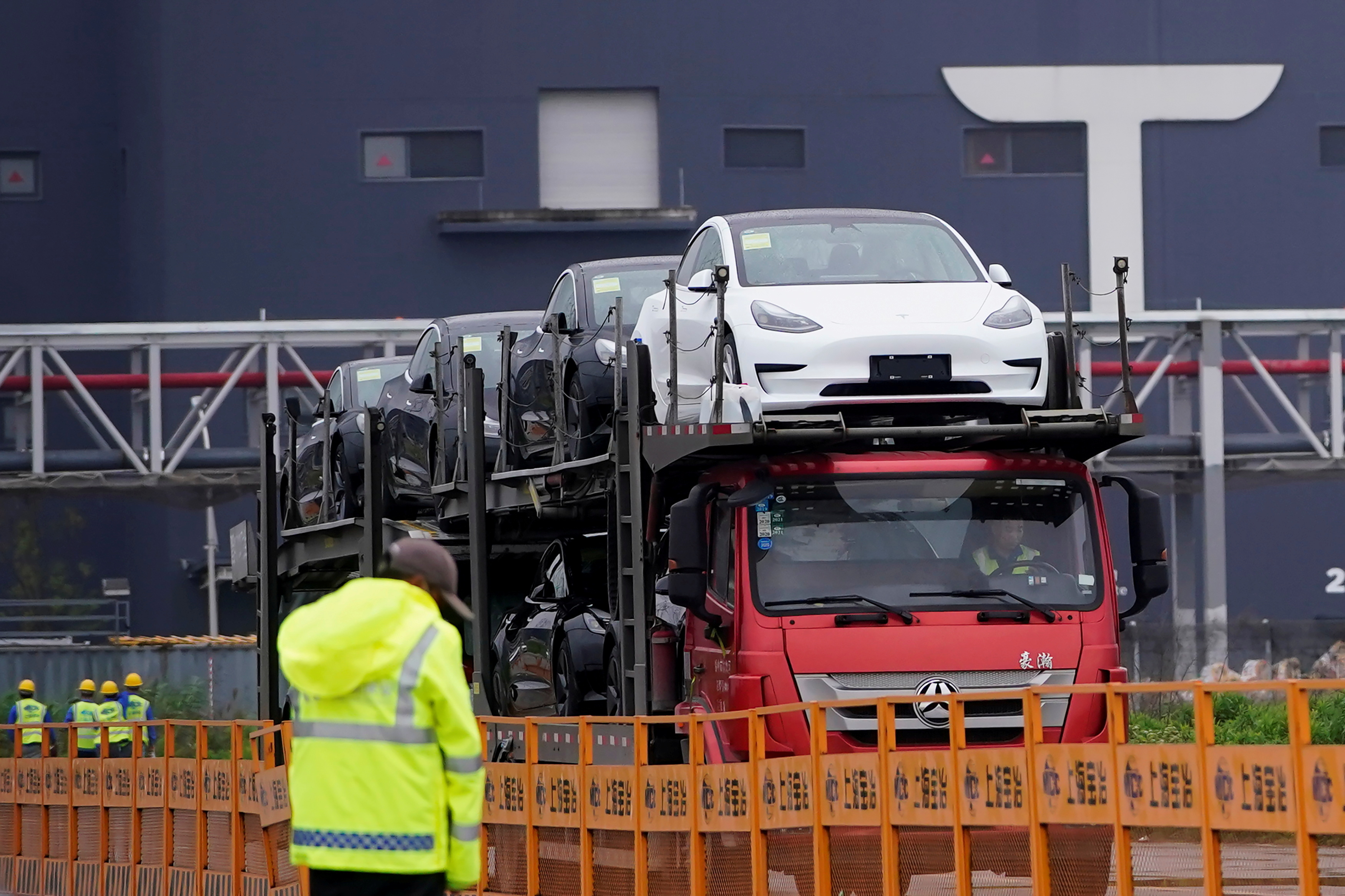 A truck transports new Tesla cars at its factory in Shanghai
