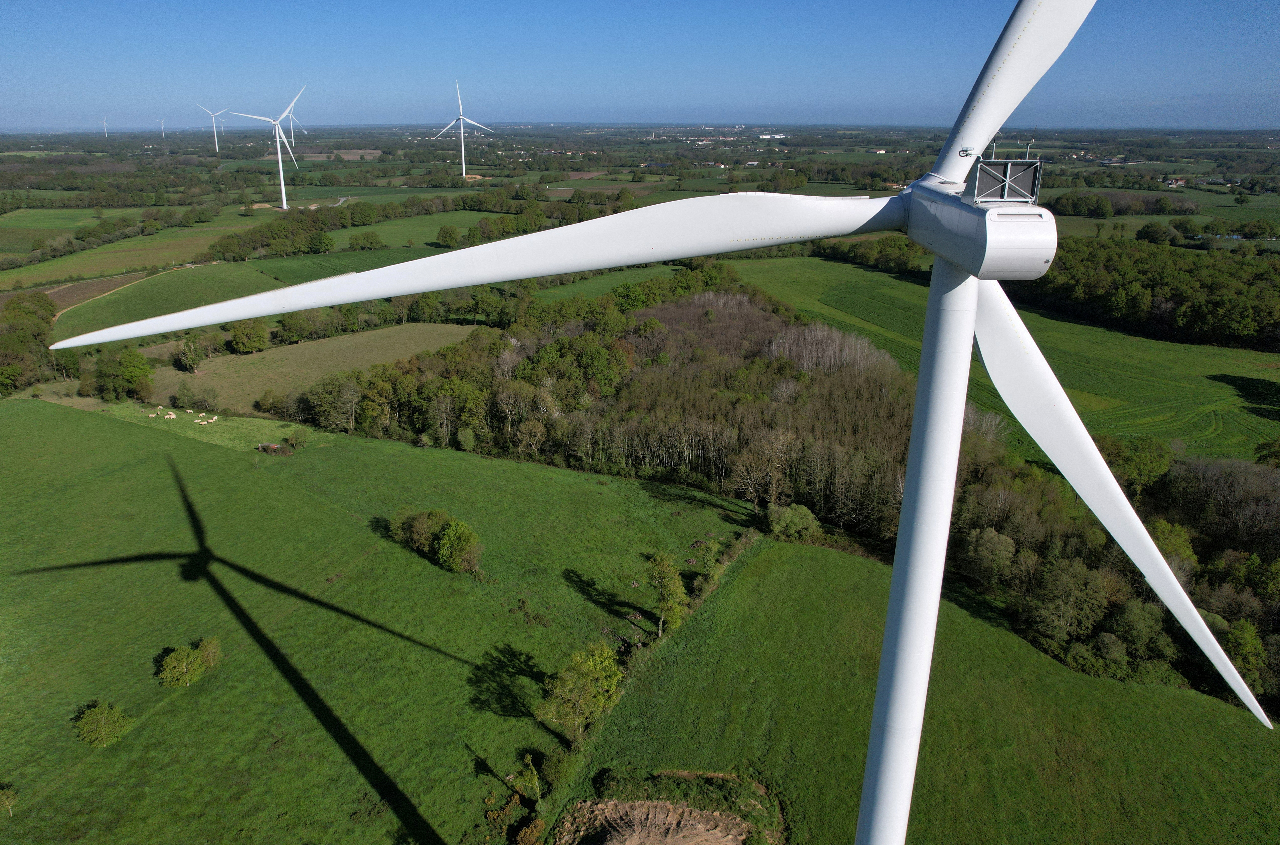 A drone view of power-generating windmill turbines in La Regrippiere