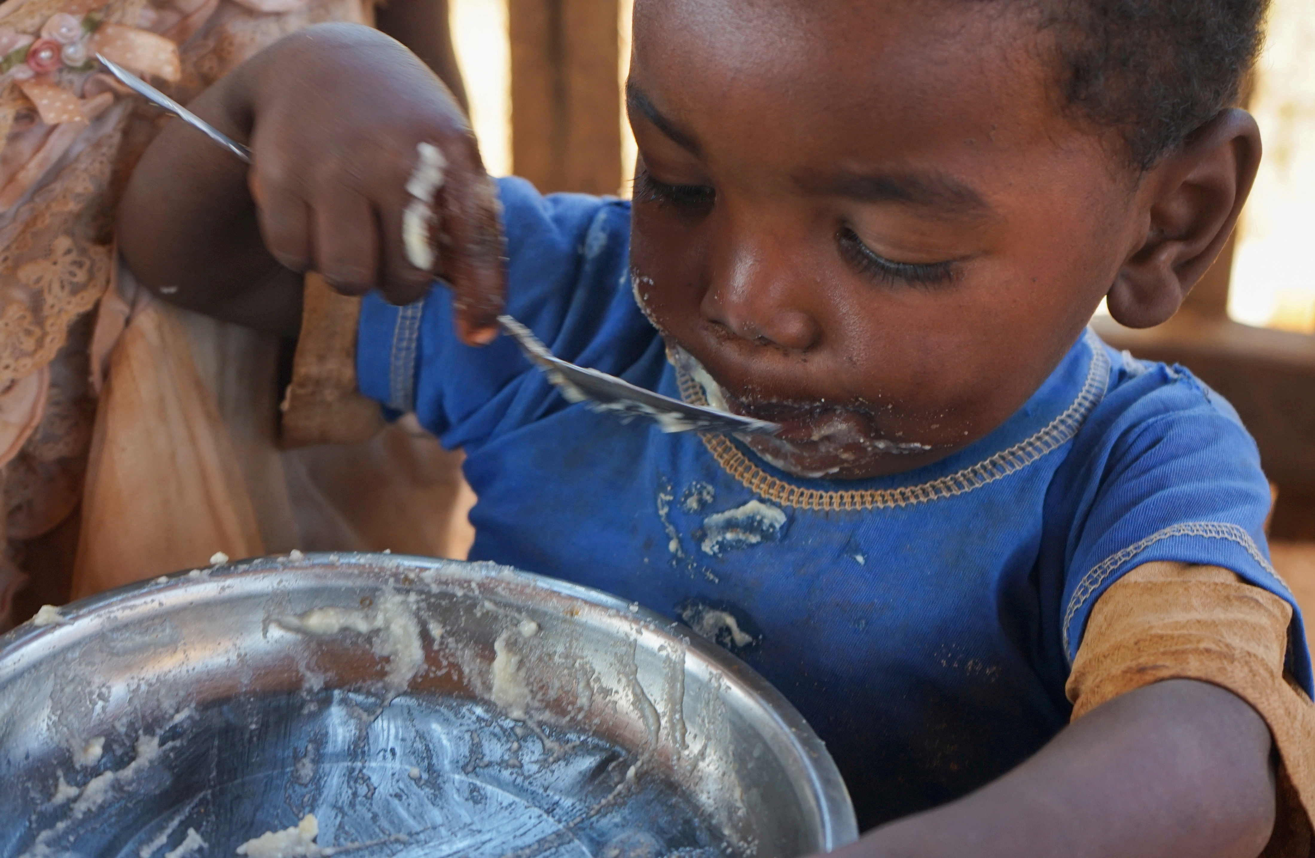A Malagasy child eats a meal at the Avotse feeding program that benefits malnourished children with hot meals in Maropia Nord village in the region of Anosy, southern Madagascar September 30, 2021. Picture taken September 30, 2021. REUTERS/Joel Kouam