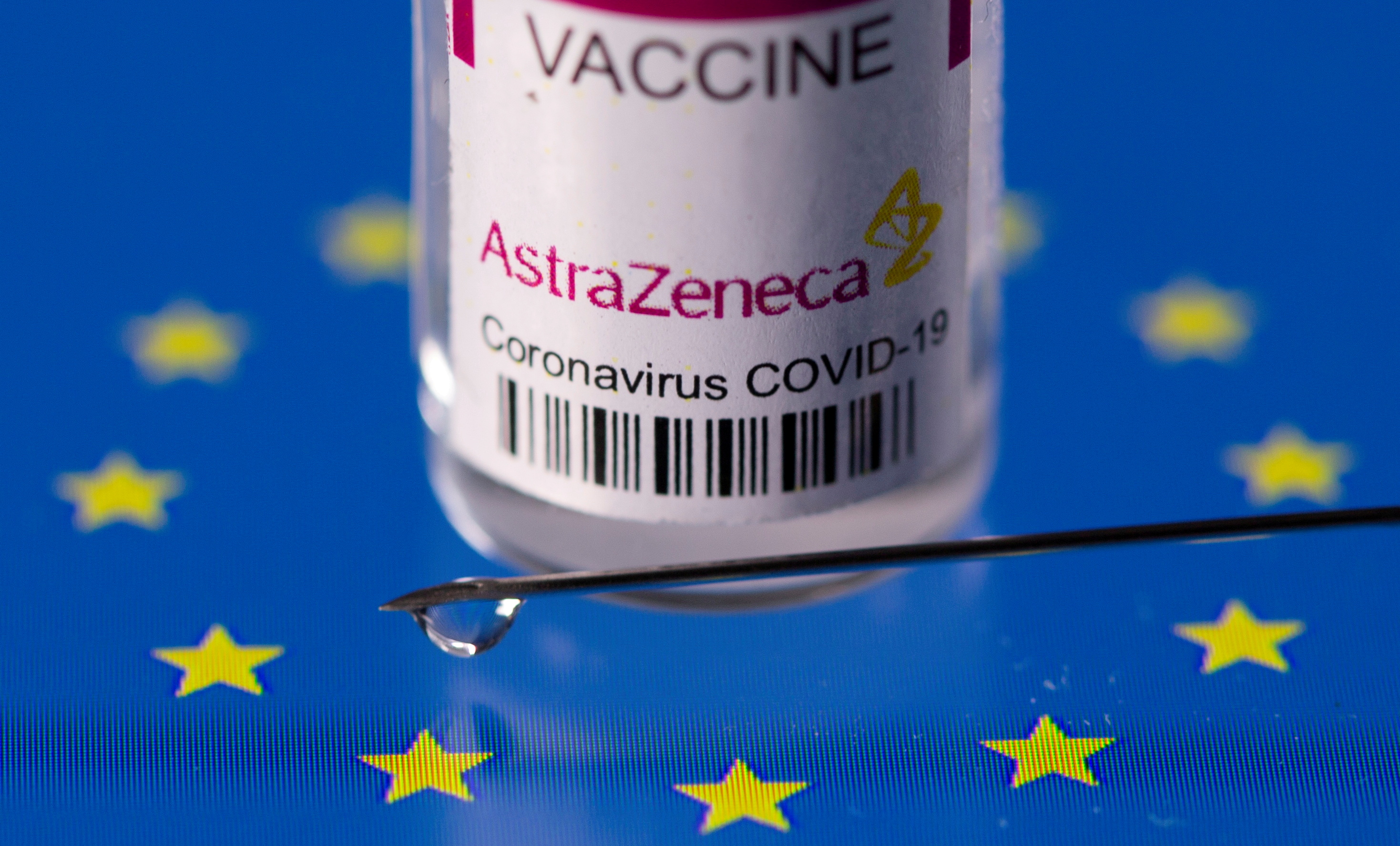 Vial labelled "AstraZeneca coronavirus disease (COVID-19) vaccine" placed on displayed EU flag is seen in this illustration picture